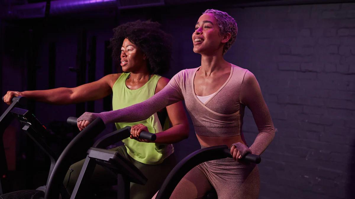two women working out on eliptical machines