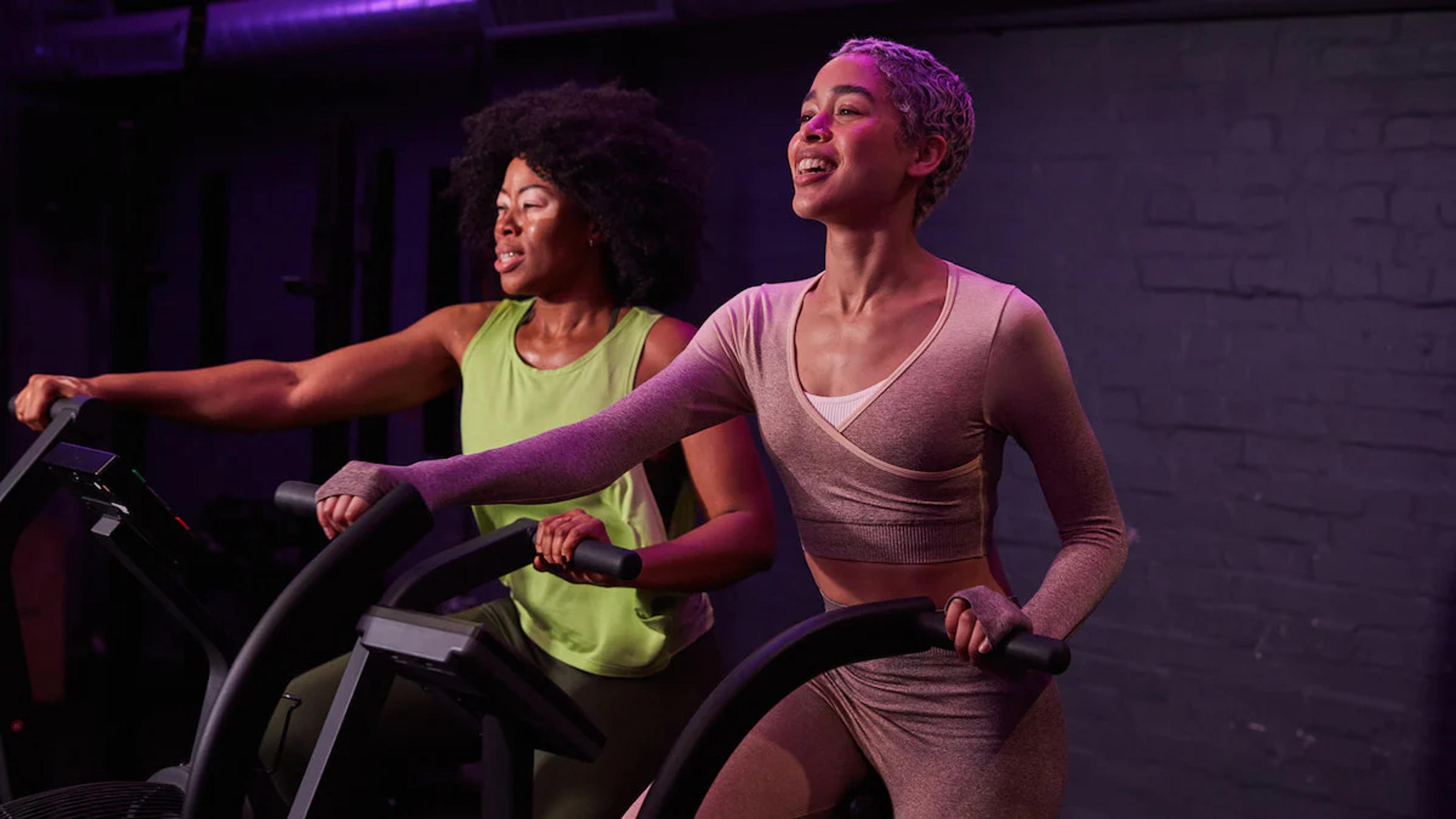 two women working out on eliptical machines
