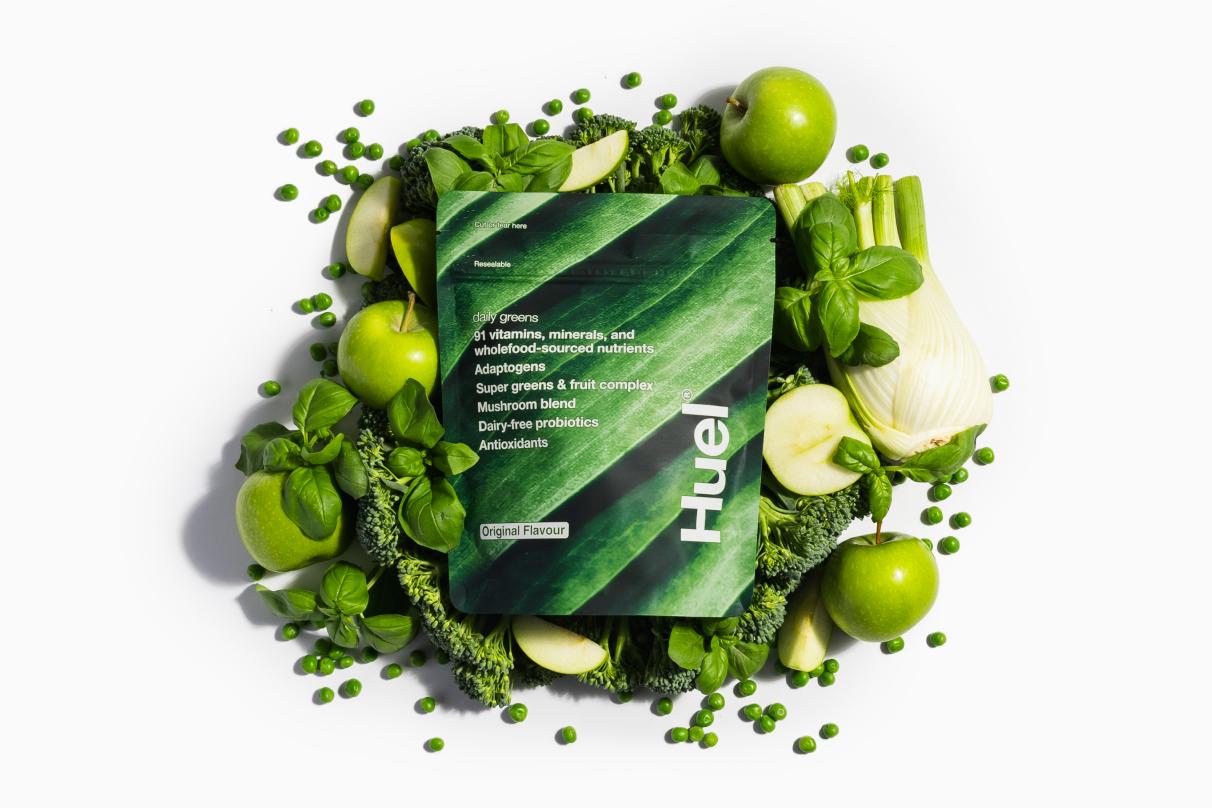 Huel Daily Greens Surrounded by Green Fruits/Veg