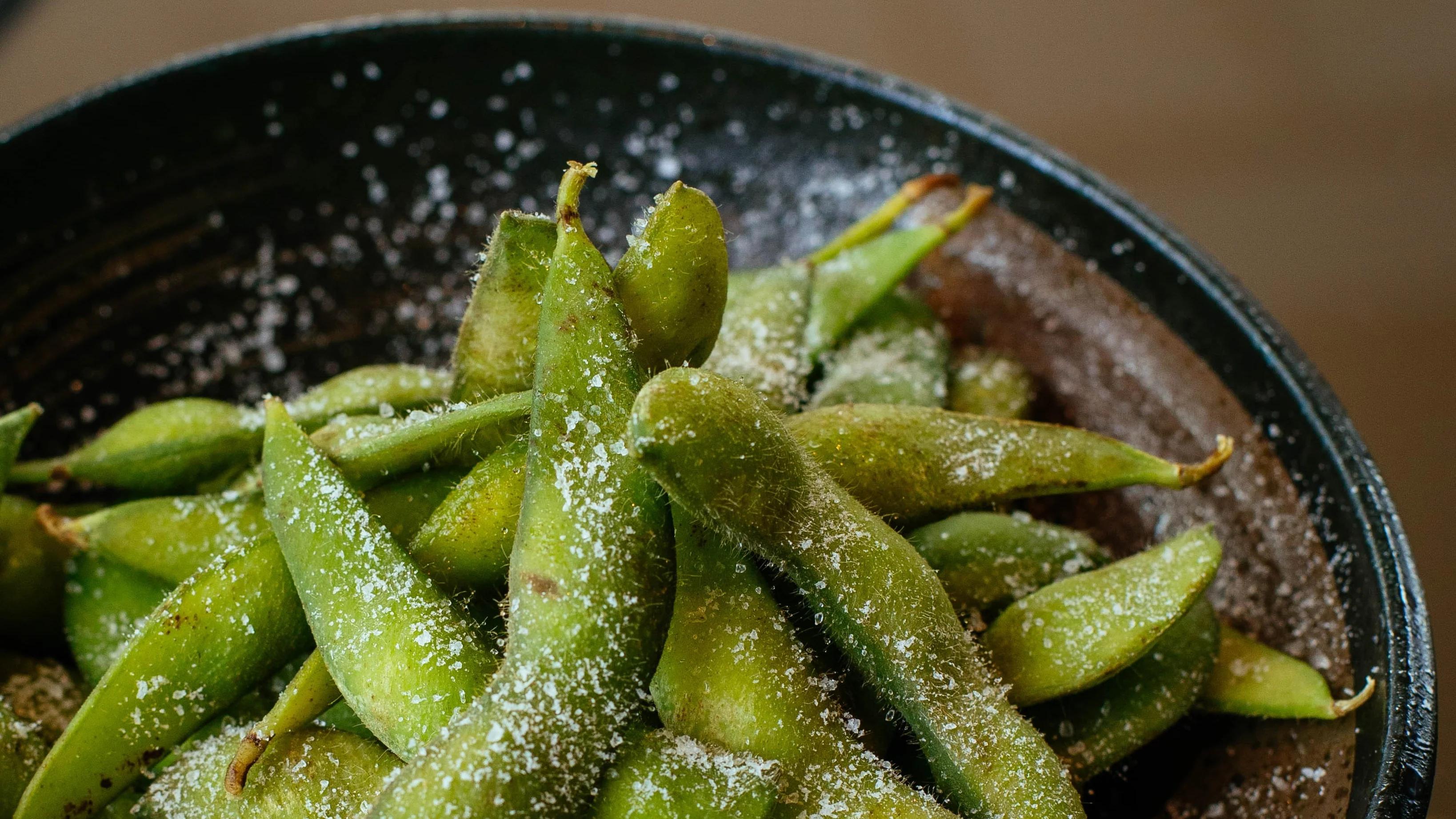 Edamame peas in a bowl with salt on top