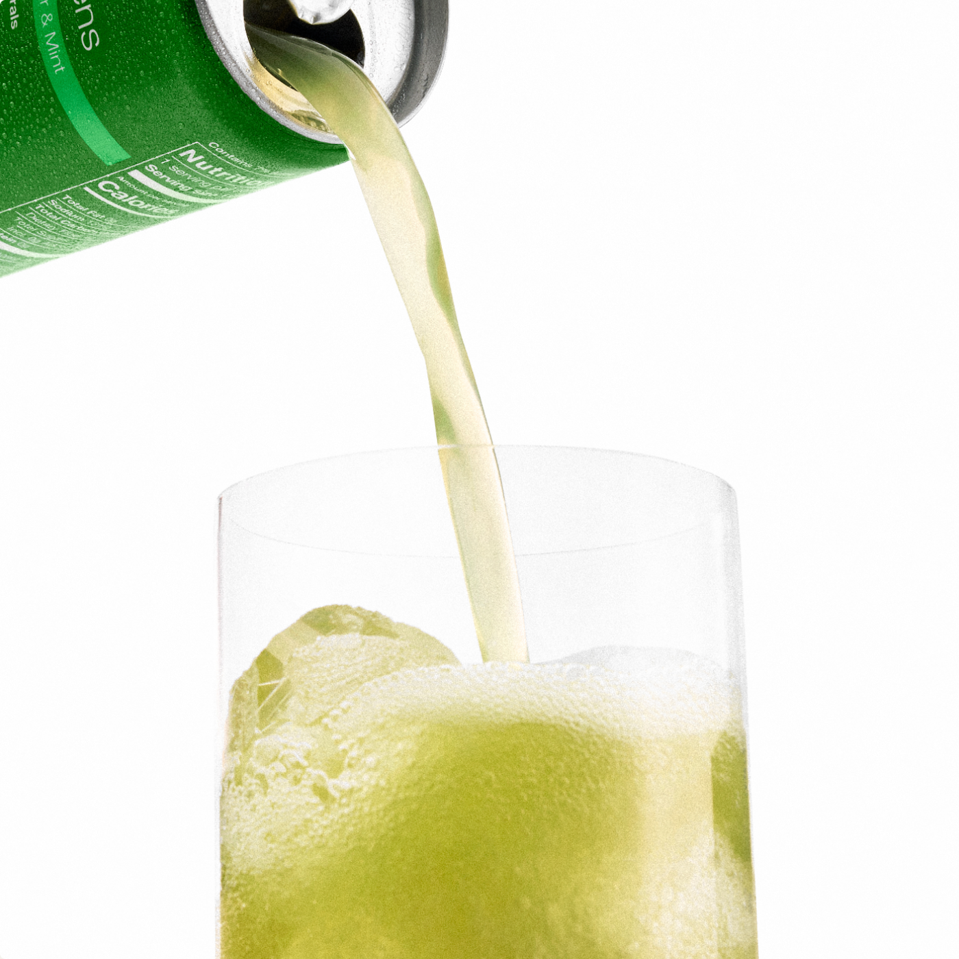 A can of Daily Greens Ready-to-drink pouring into a glass with ice