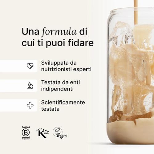 A glass of ice being filled by huel complete protein liquid