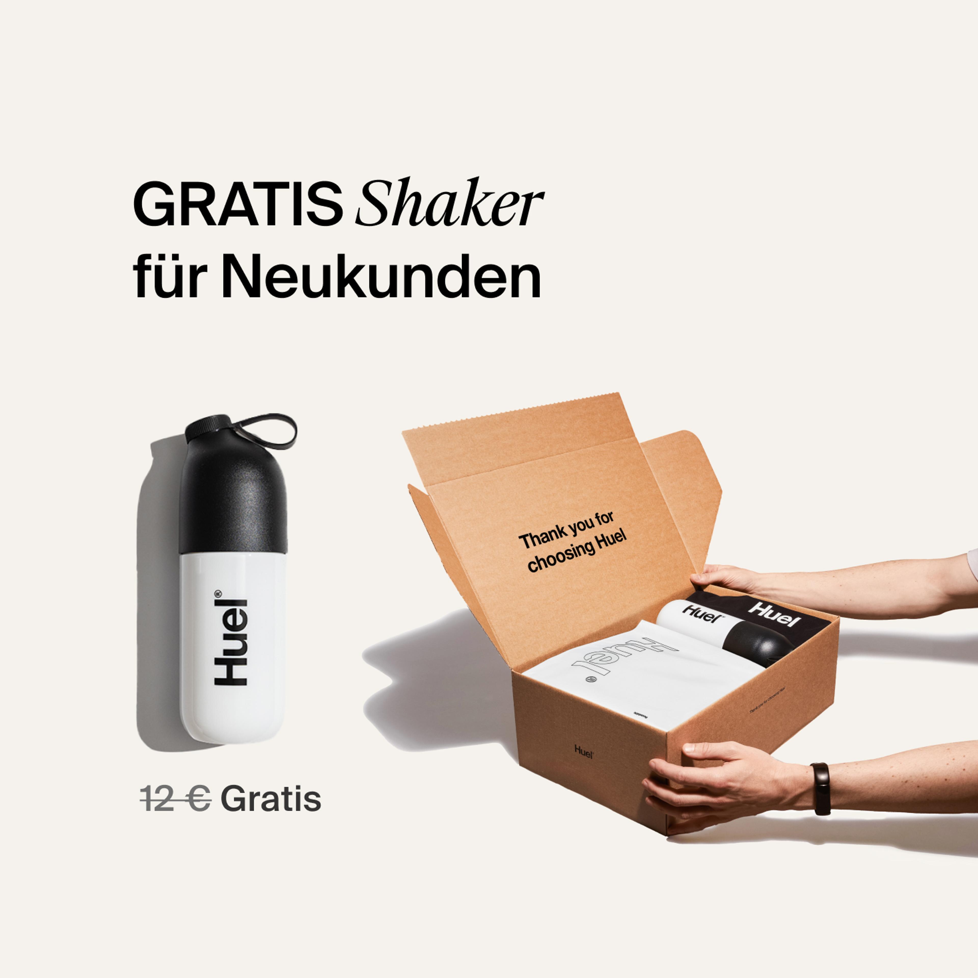 someone holding a Huel box containing a white powder bag, and a black and white shaker, on a neutral background