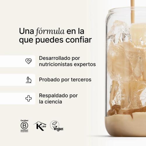 A glass of ice being filled by huel complete protein liquid
