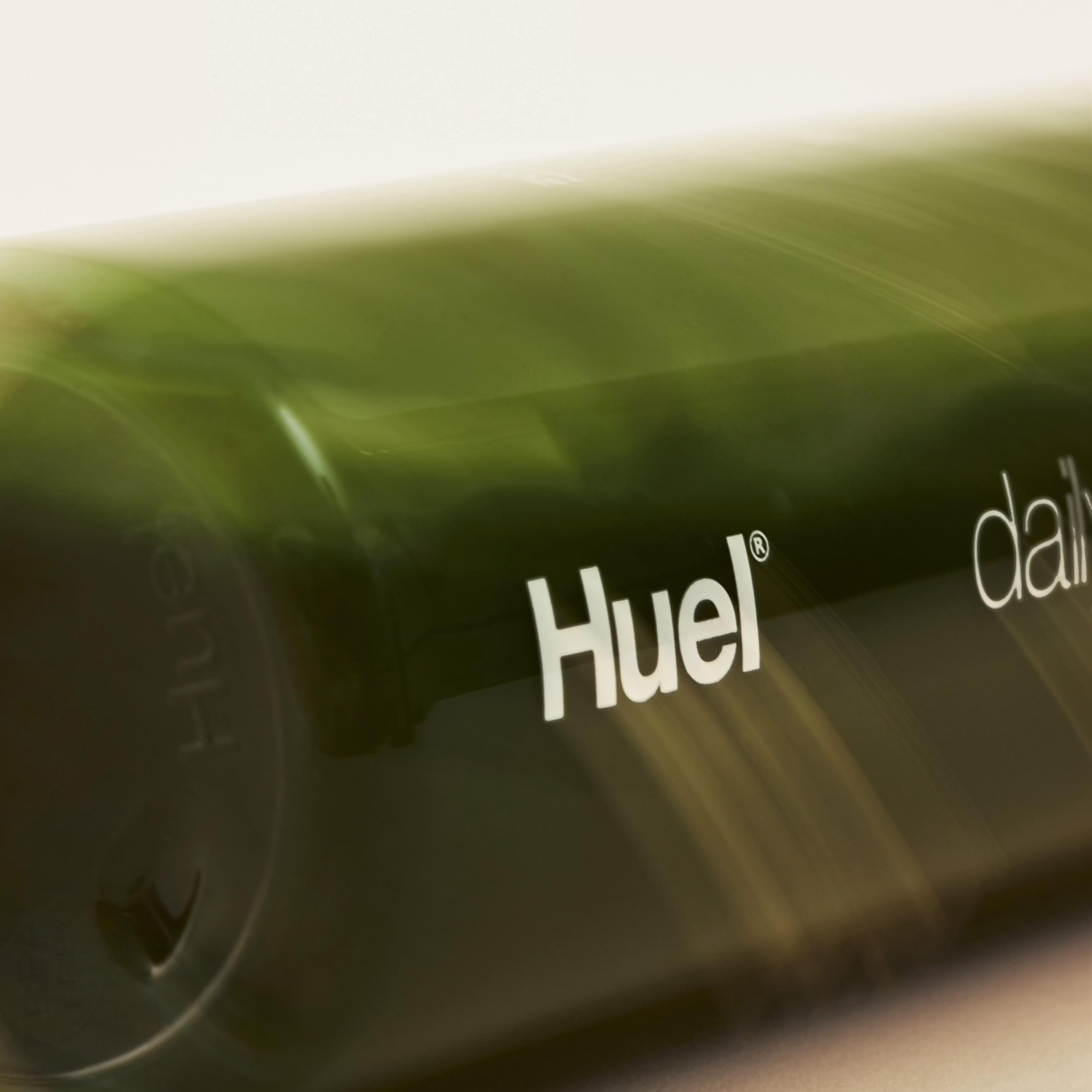 Extreme close-up on Huel Daily Greens bottle filled with greens drink liquid