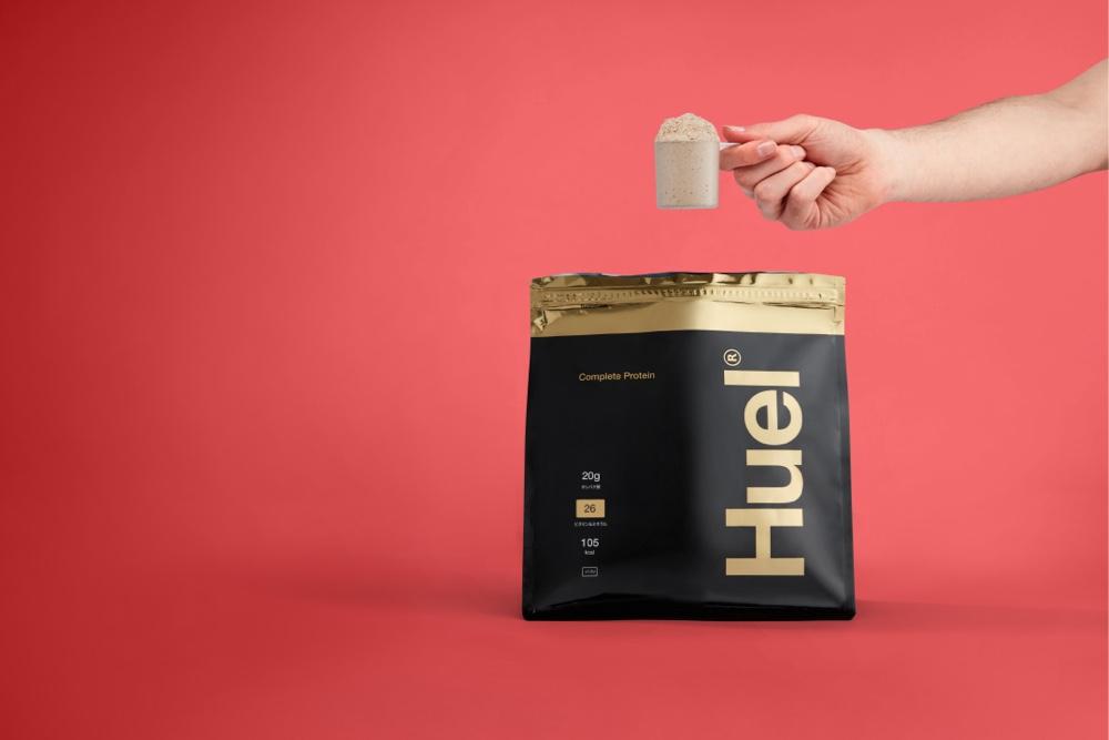 Black and gold Japanese Huel Complete Protein bag on a red background