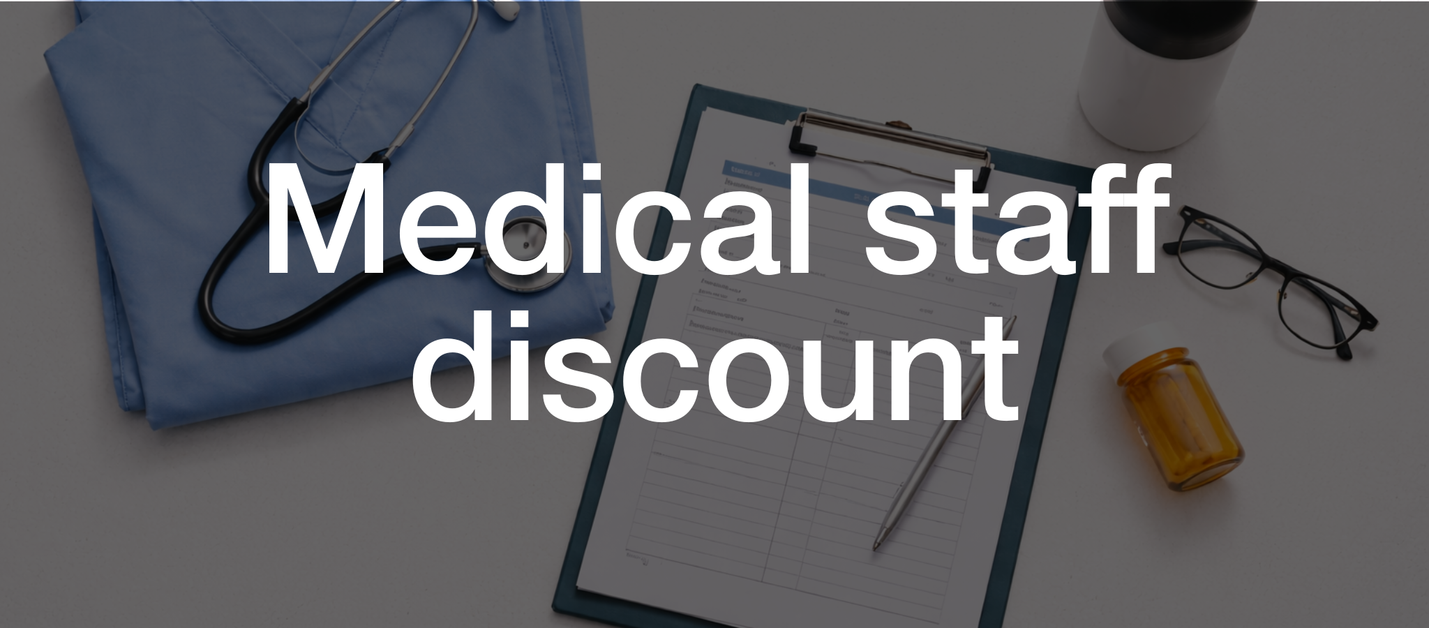 Cropped image of someone wearing light blue scrubs while holding a Huel Shaker bottle