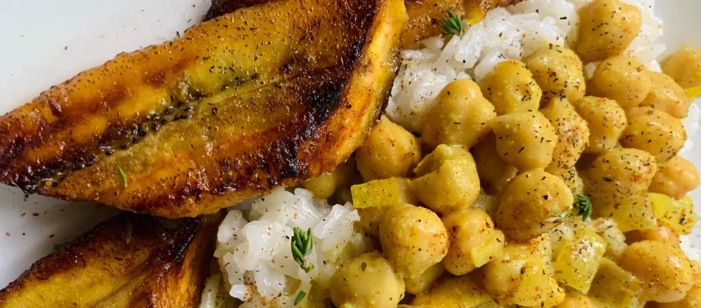 chickpea curry with plantin on the side close up image