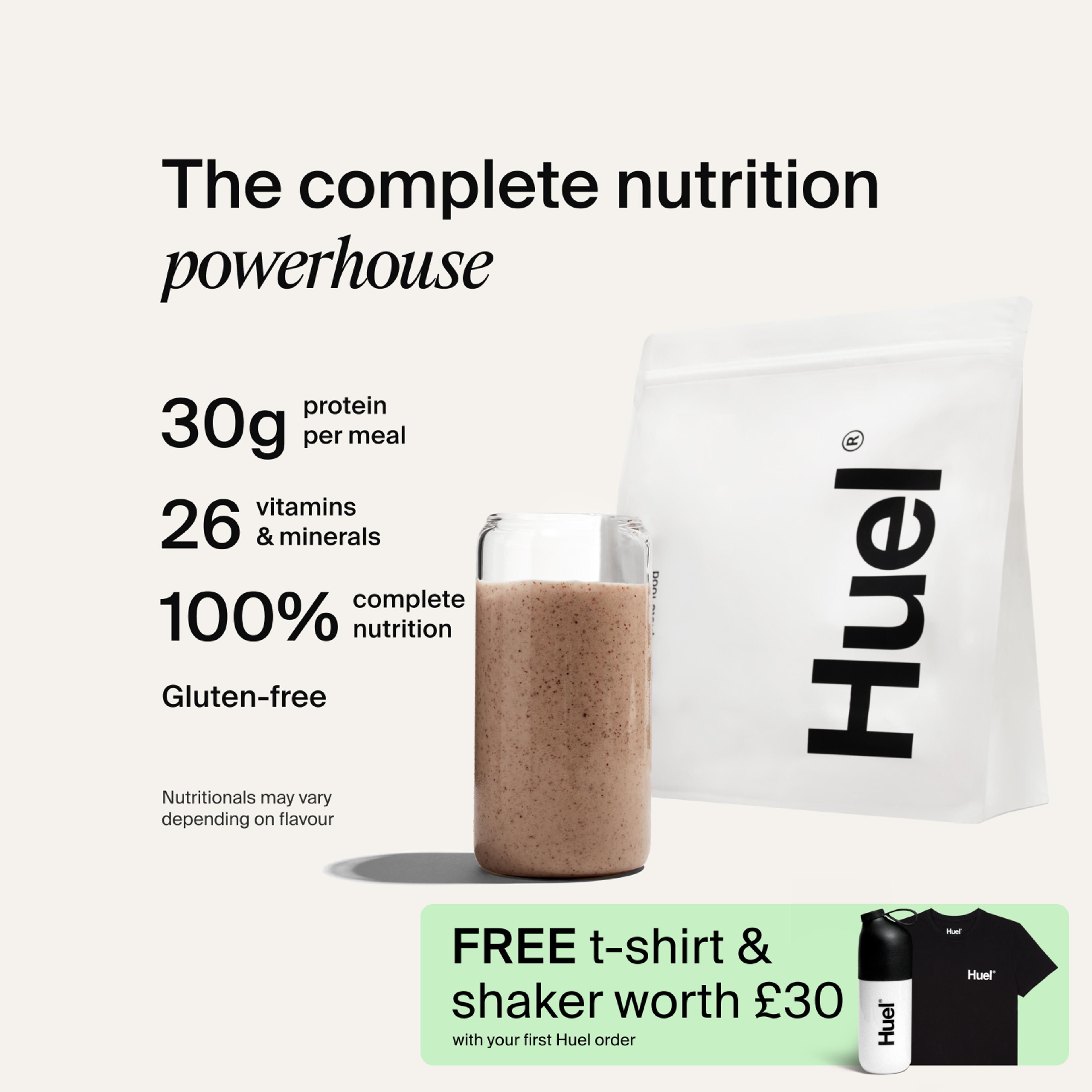 A bag of Huel powder next to a glass containing a Huel drink on a neutral background
