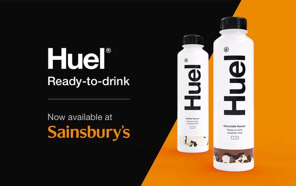 Two Huel Ready-to-drinks on an orange and black background promoting the launch in Sainsburys
