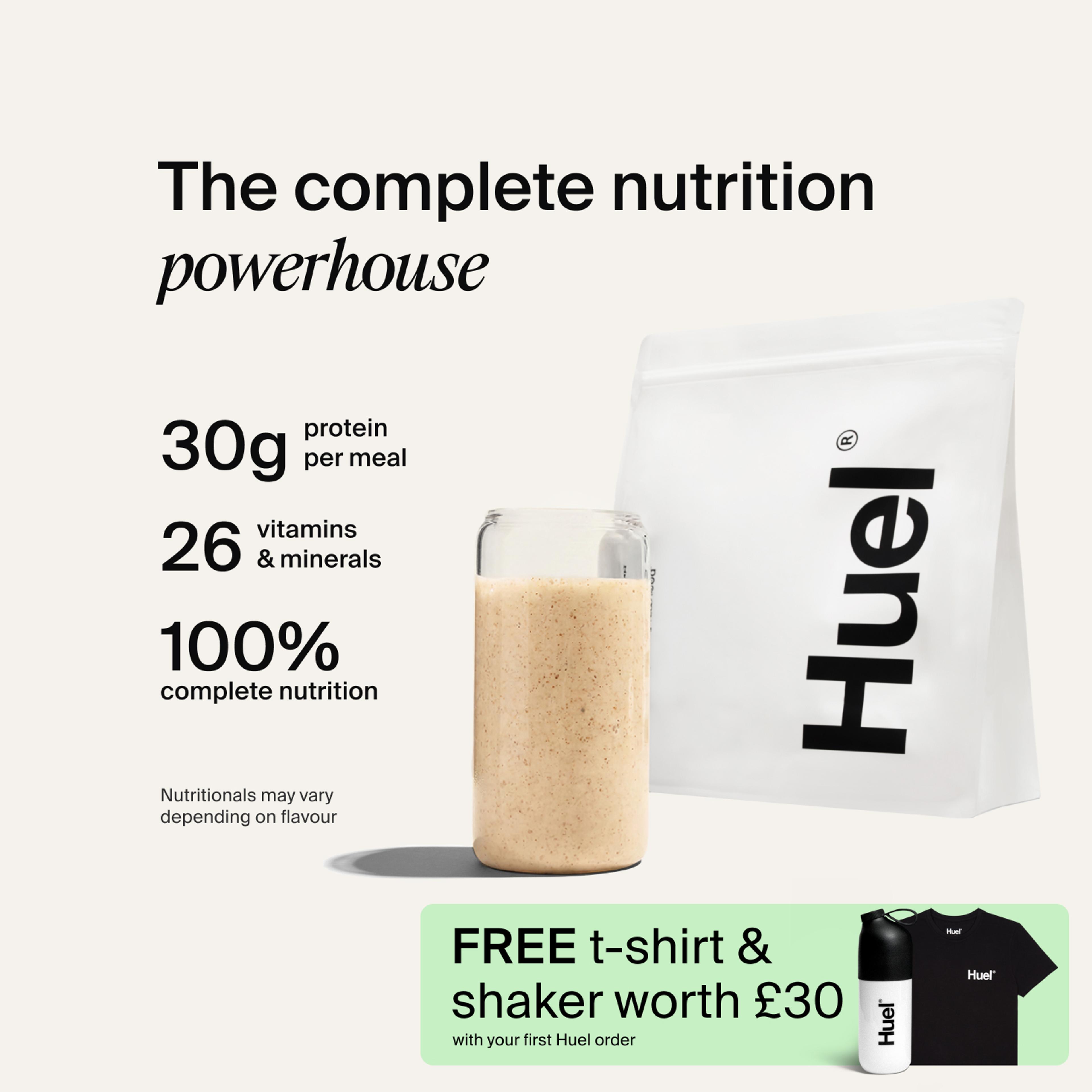 A bag of Huel powder next to a glass containing a Huel drink on a neutral background