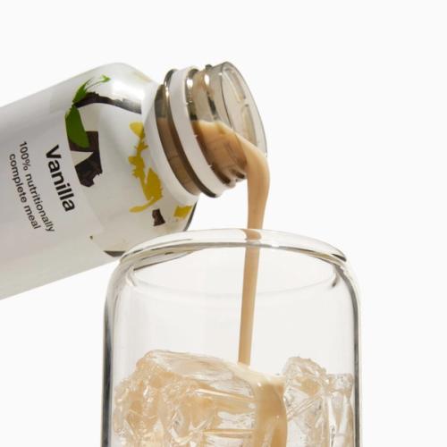 Vanilla Huel RTD being poured into a glass with ice