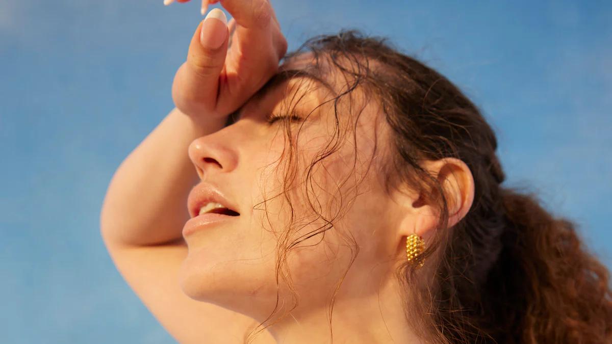 woman wiping her brow with her forearm under the hot sun