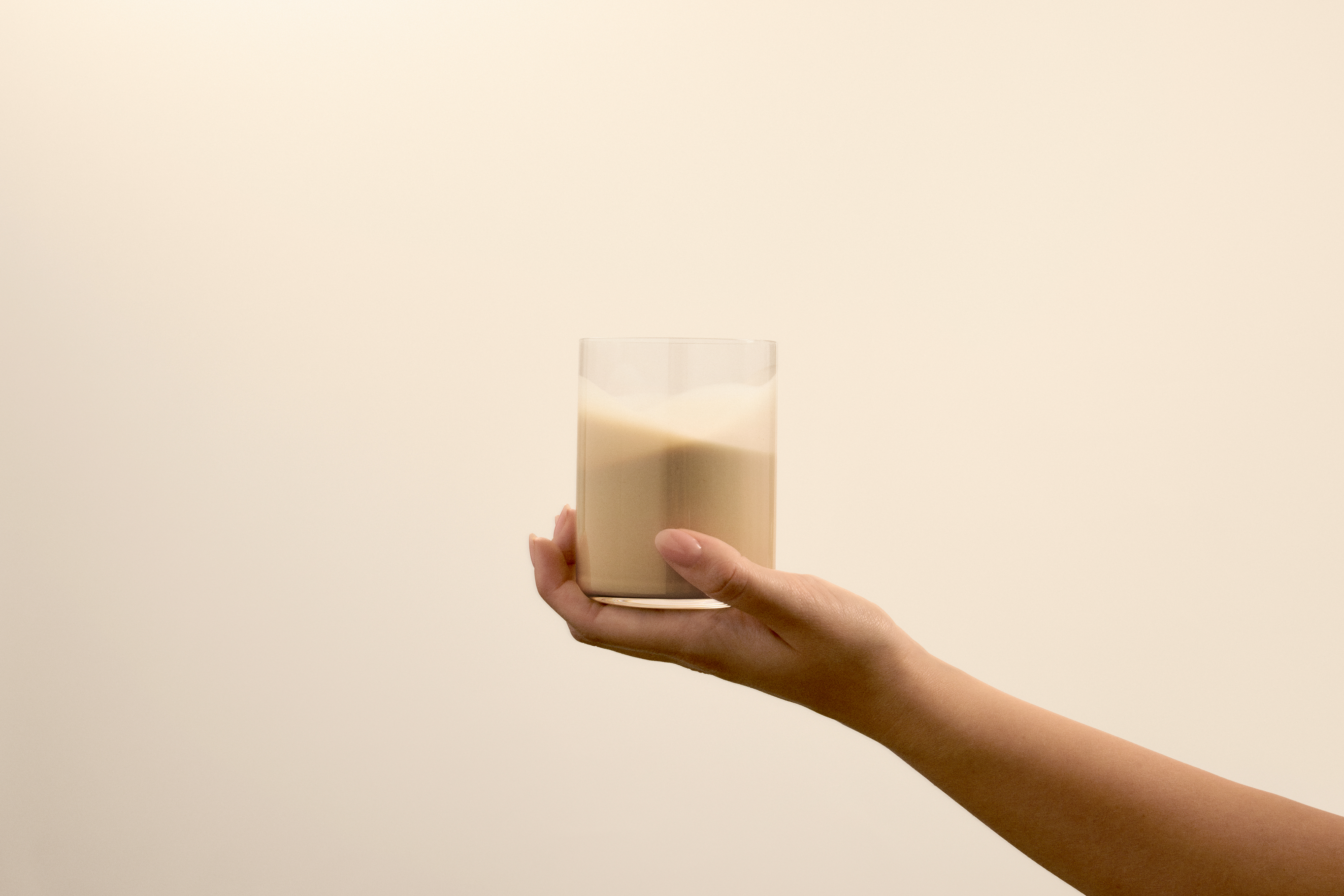Image of person holding a glass of Huel