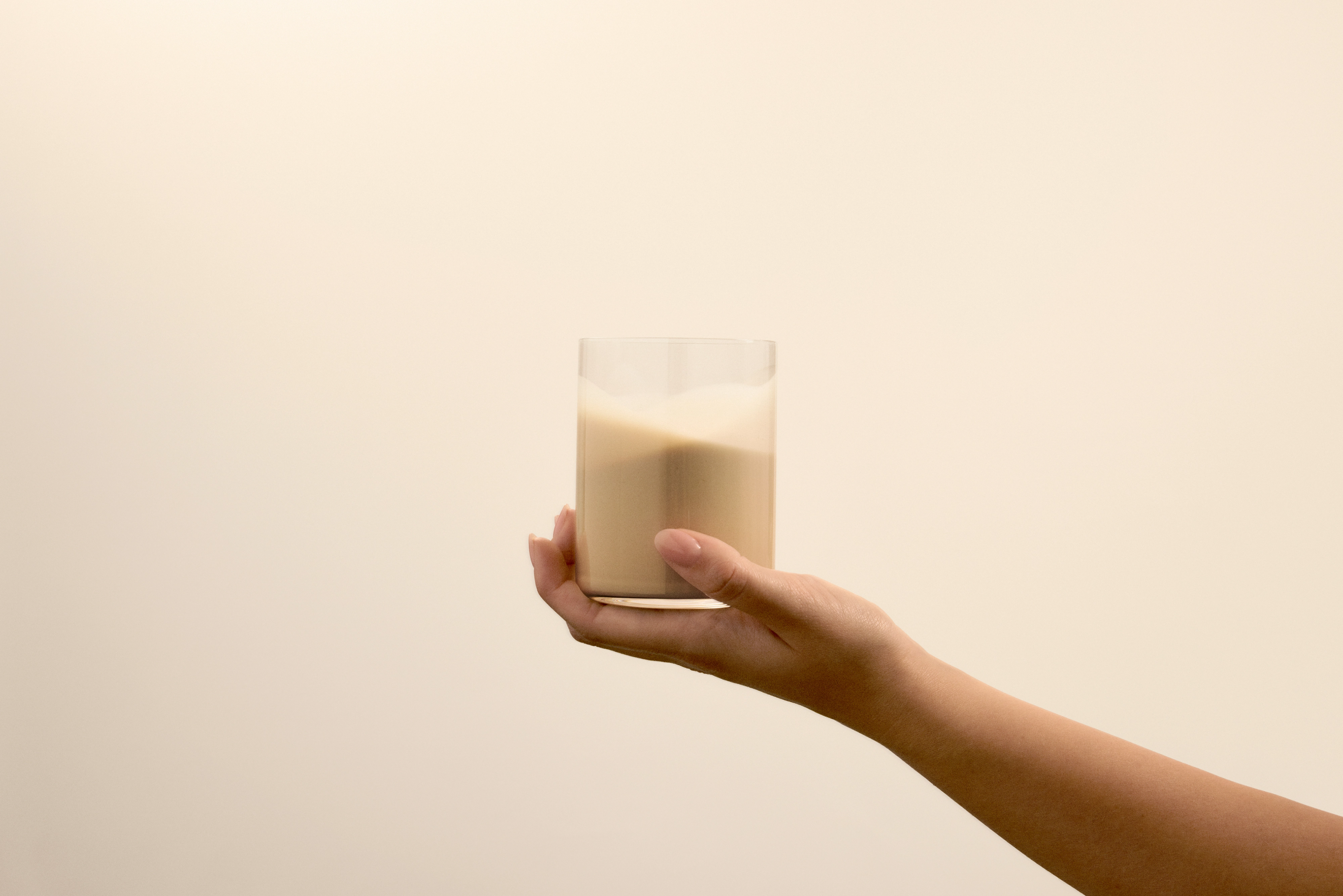 Image of person holding a glass of Huel