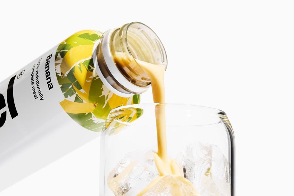 Banana Huel Ready-To-Drink pouring into a glass