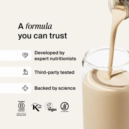 Huel RTD protein drink being poured into a glass filled with ice
