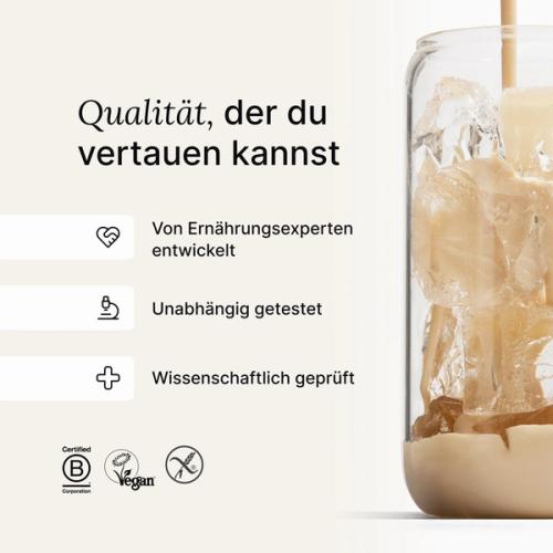 A glass of ice being filled by huel complete protein liquid