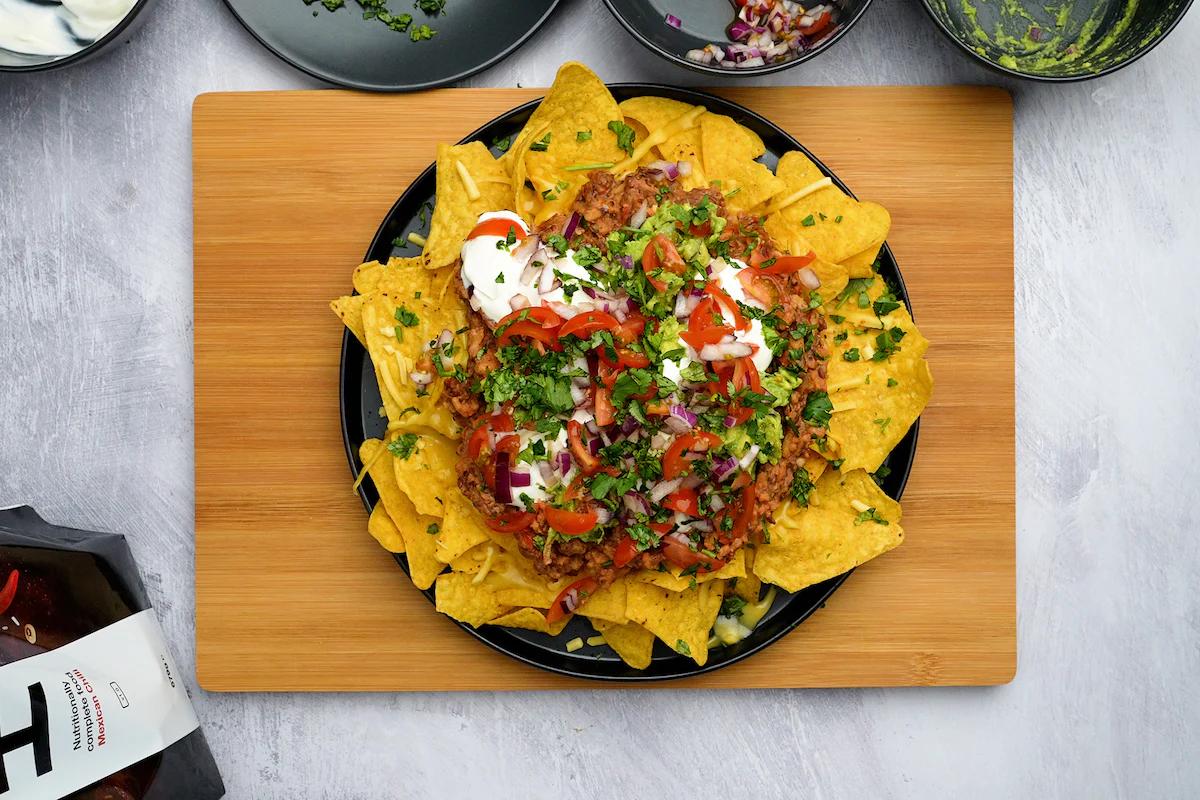 huel mexican chili nachos on a plate on a wooden board