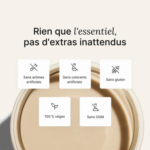 A glass of Huel complete protein shake on a neutral colour background