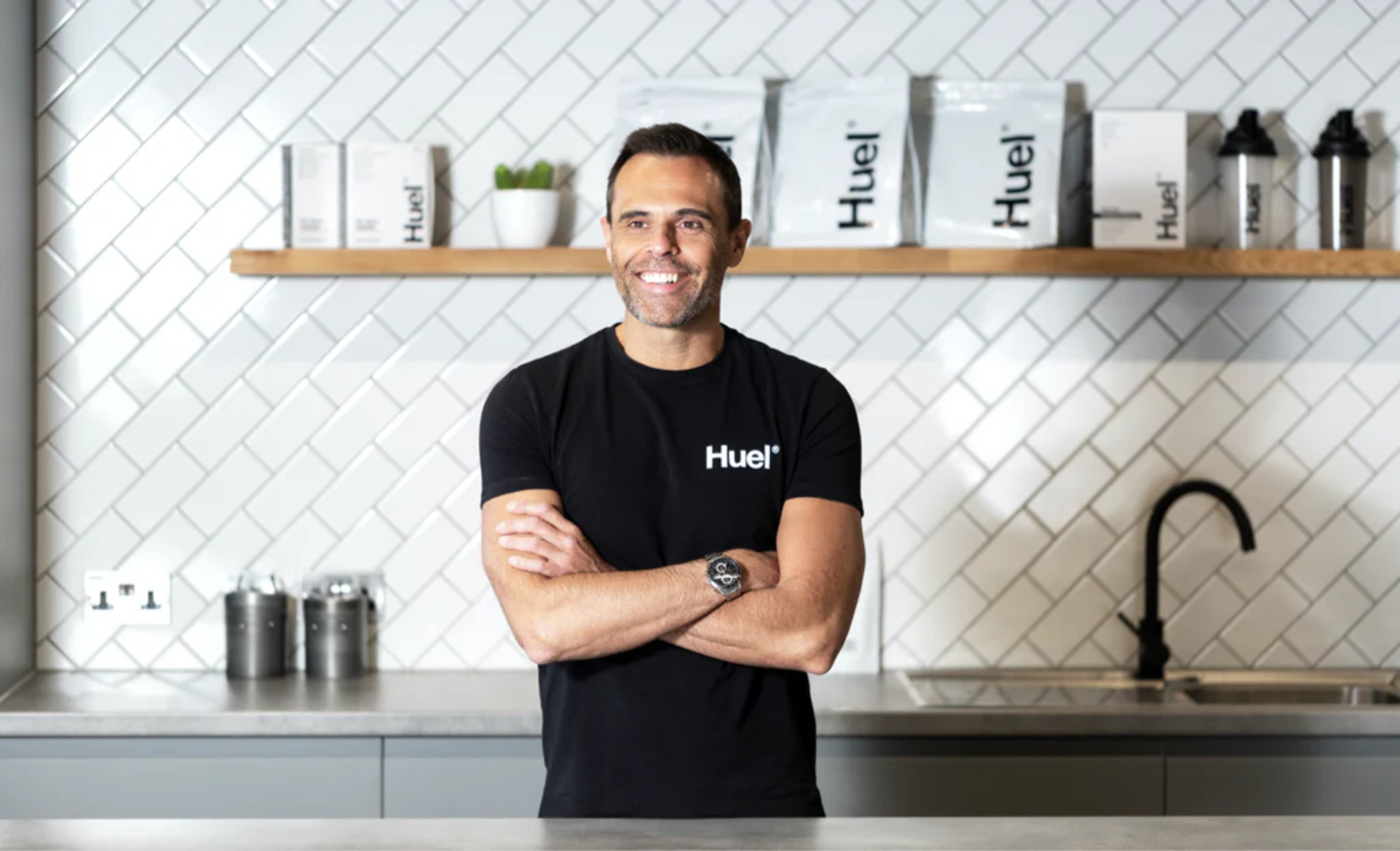An image of Julian Hearn, the founder of Huel, with his arms crossed and smiling.