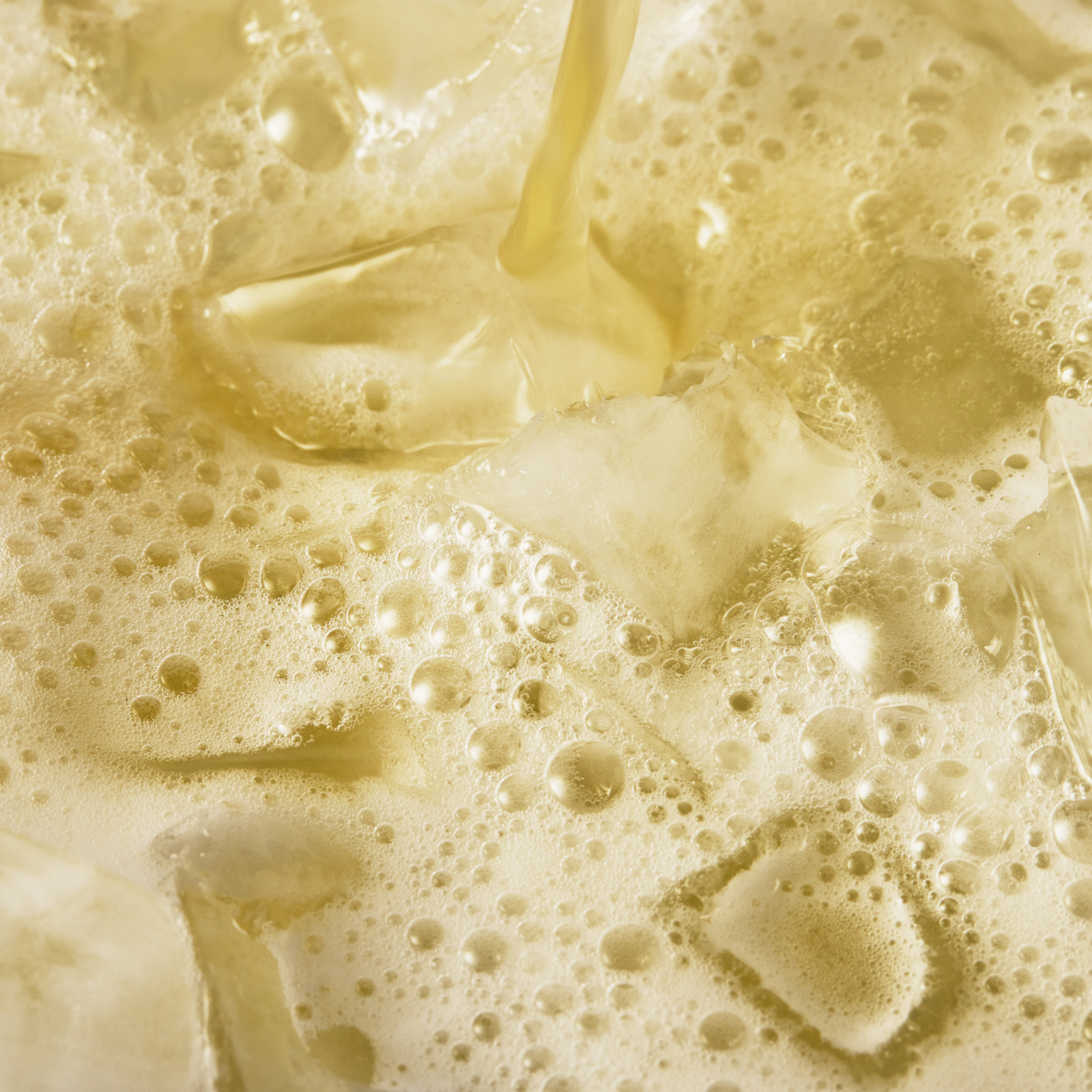 A close up of a glass of Daily Greens Ready-to-drink in a glass with ice