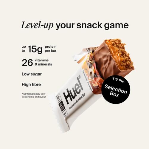 Alt: Huel Complete Nutrition Bar with a cut-open bar, alongside text highlighting up to 15g protein, 26 vitamins and minerals, low sugar, and high fibre.