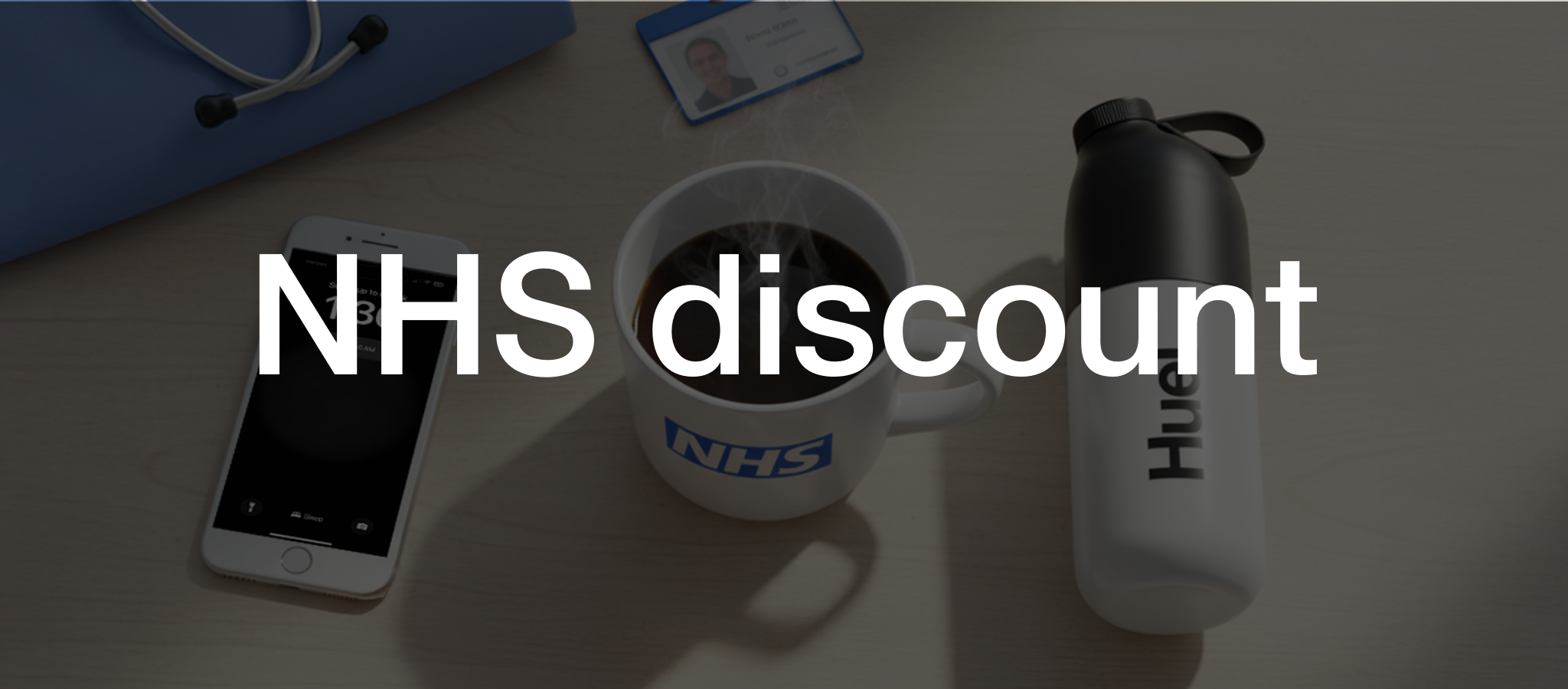 Image of a female doctor wearing blue scrubs and a stethoscope holding a Huel Shaker