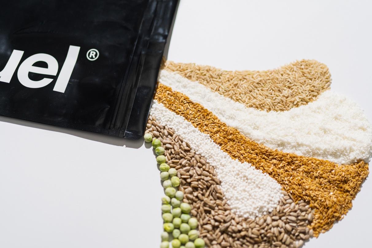 Huel Black Edition Raw Ingredients spilling from a black edition pouch