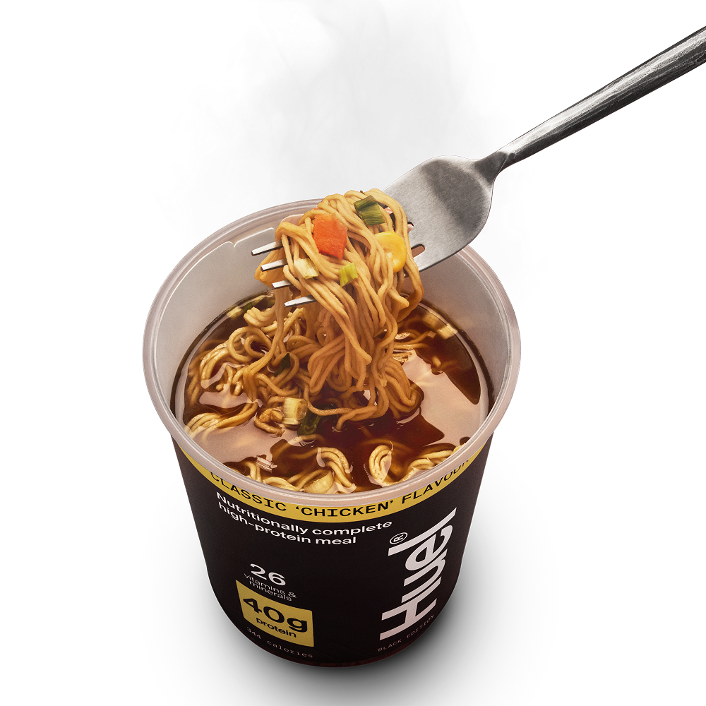 A Huel Black Edition Ramen in Classic 'Chicken' flavour with a fork pulling noodles out on a white background