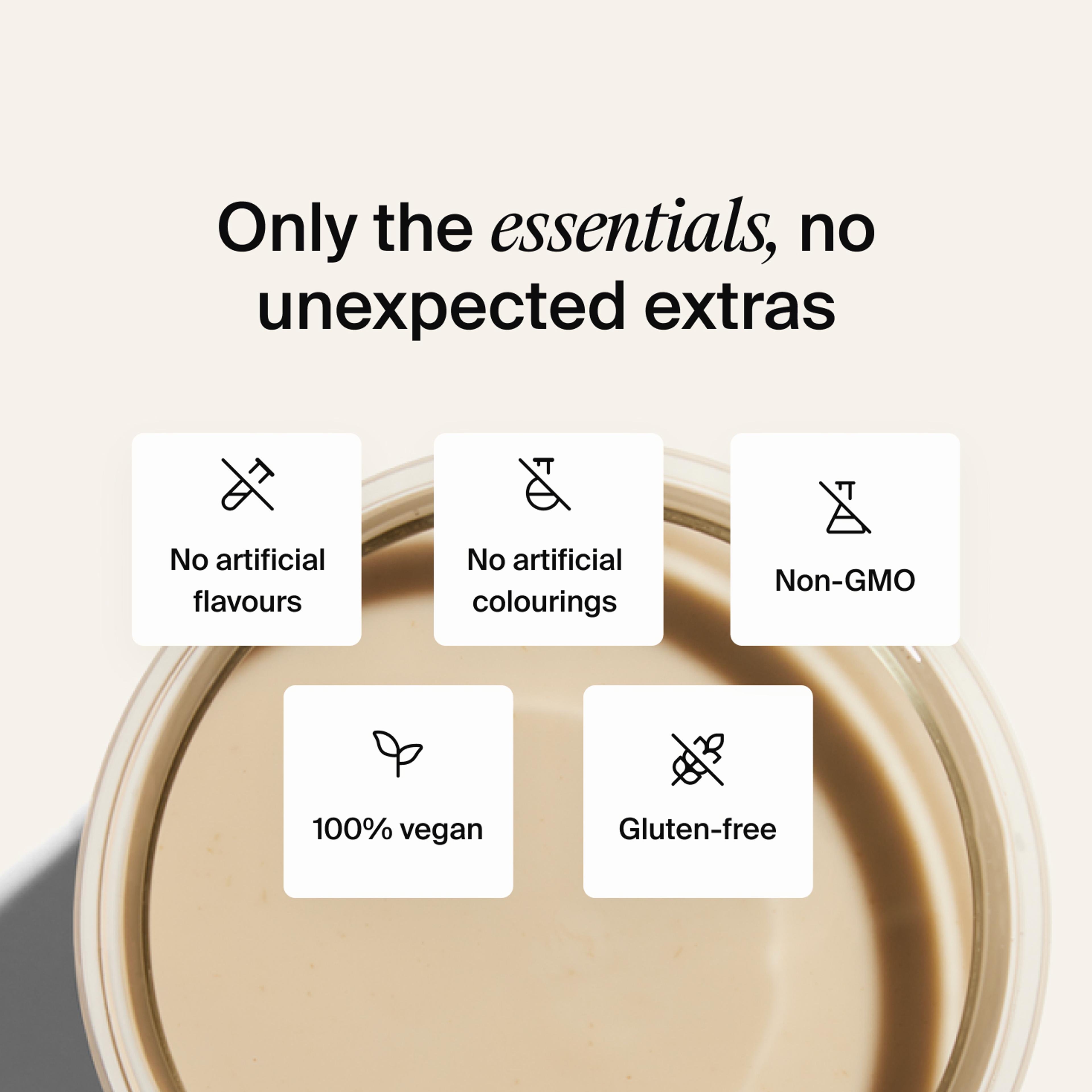 A glass of Huel complete protein shake on a neutral colour background