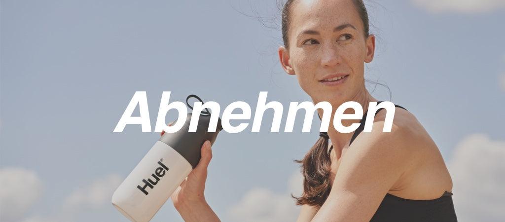 A person holding a Huel shaker