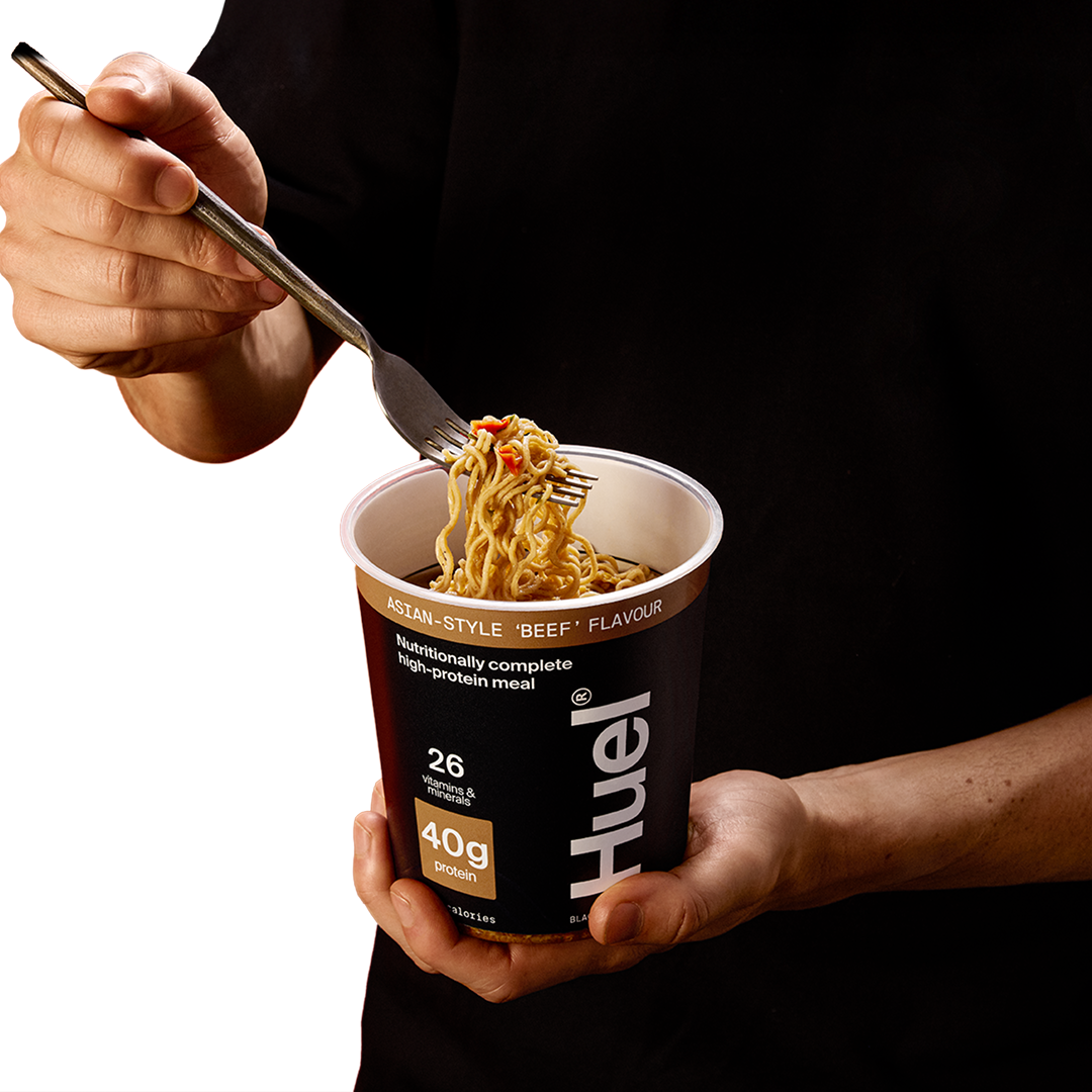 A fork pulling the noodles of the Huel Black Edition Ramen put out to show the contents