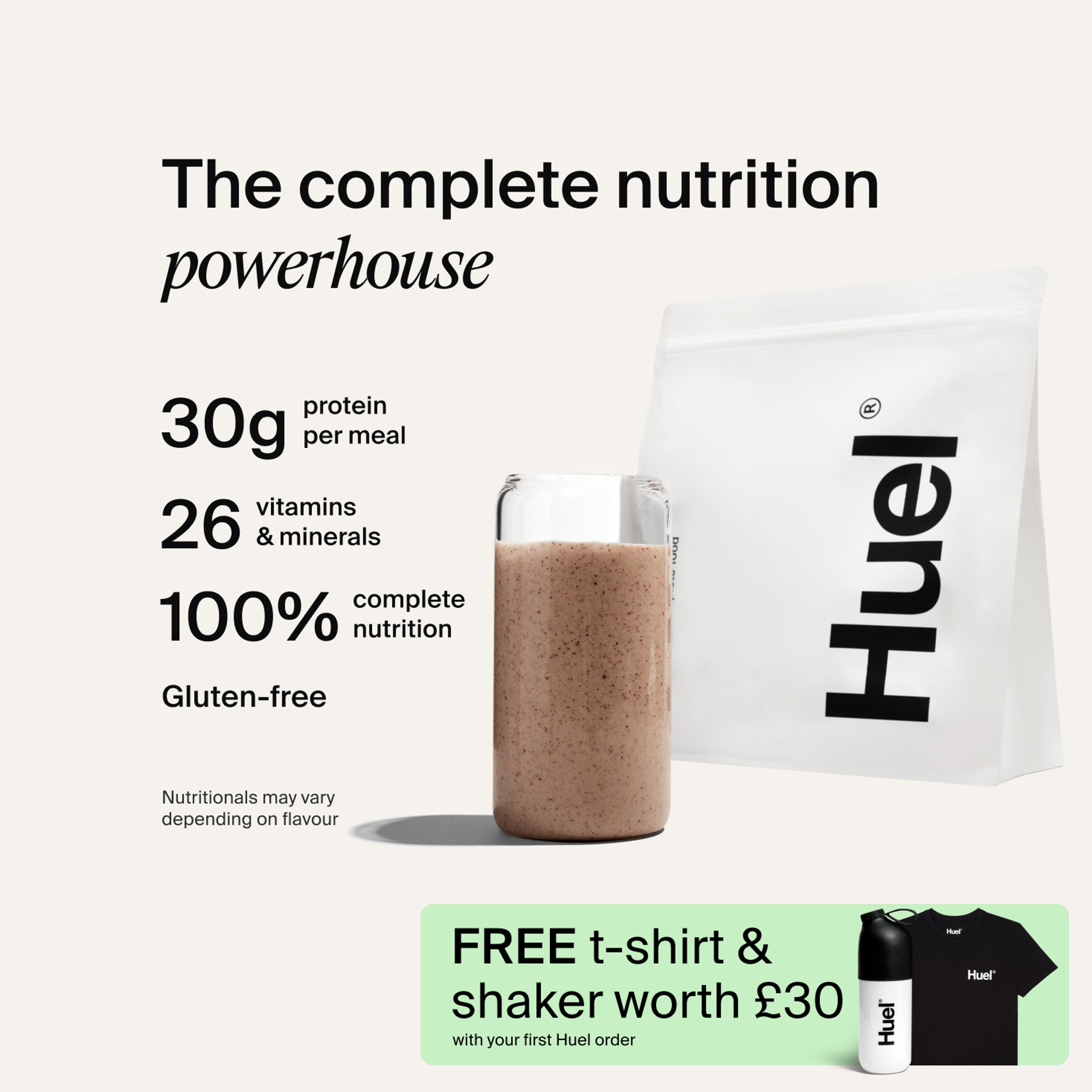 A bag of Huel powder next to a glass containing a Huel drink on a neutral background