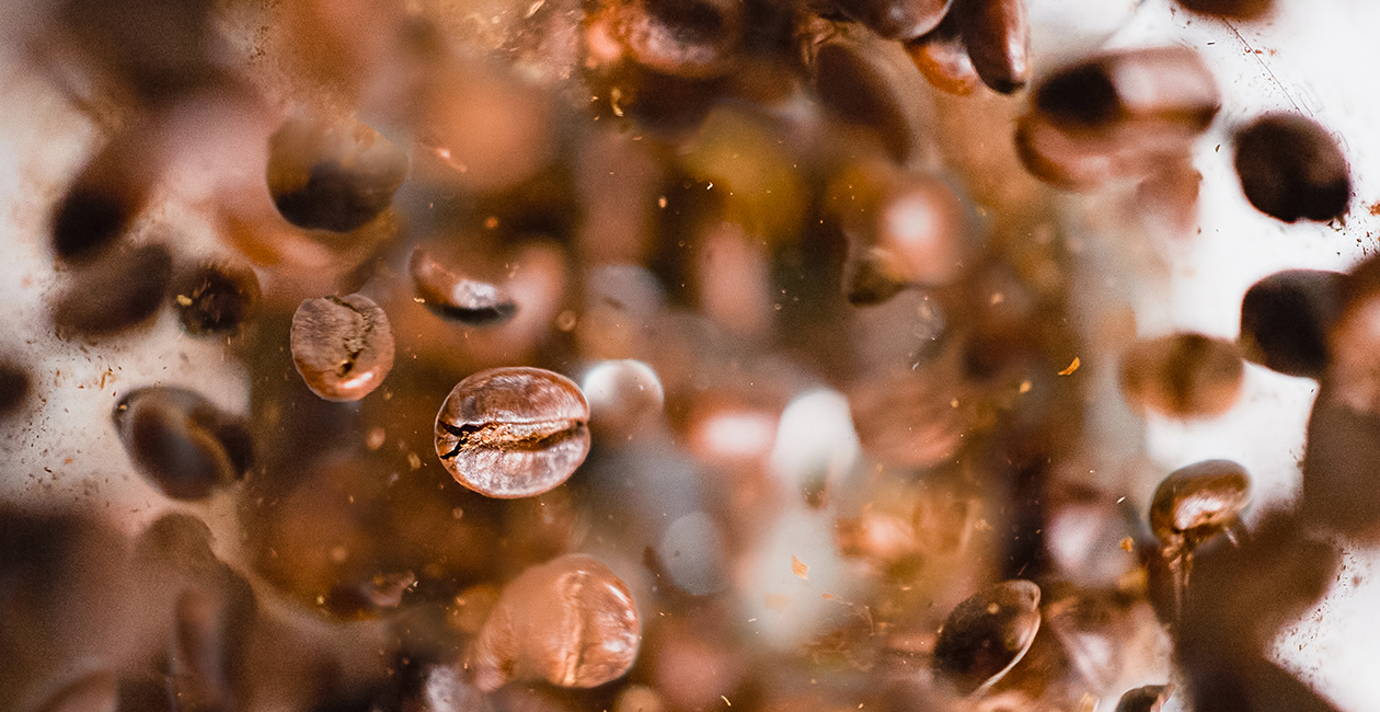 Coffee beans flying around with a blurred background