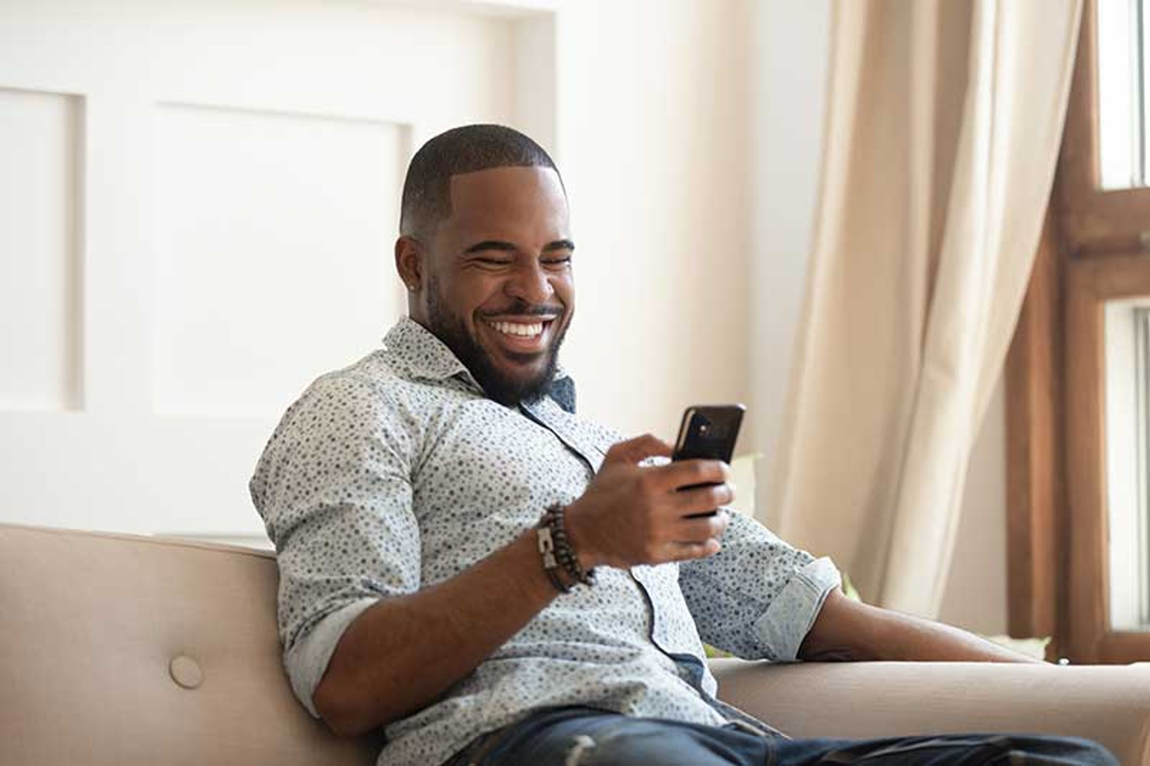 Guy laughing at phone