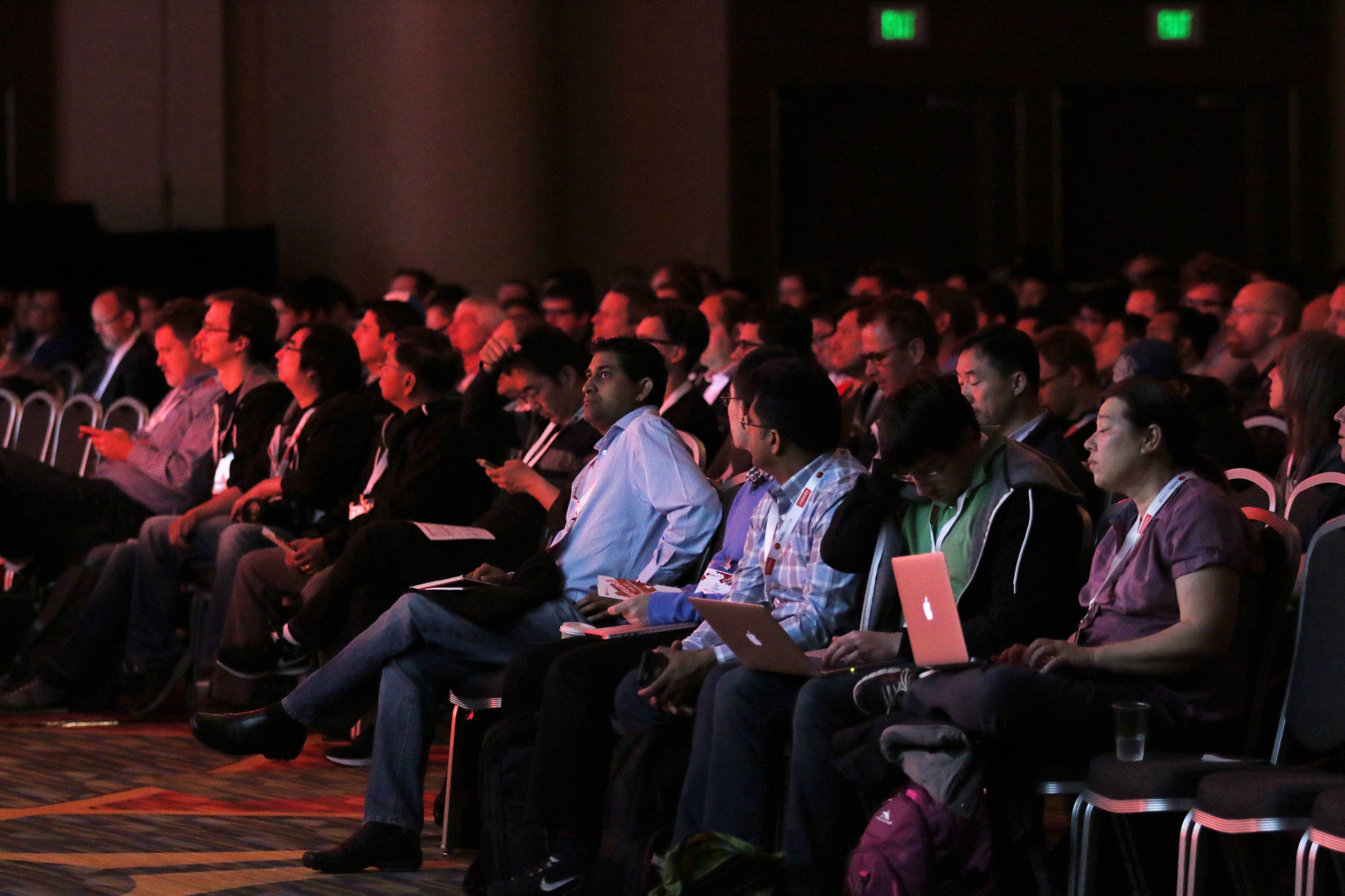 Audience members watch the RedisConf keynotes
