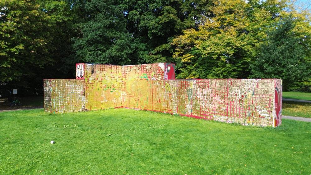 Photograph of the artwork Muralarum, 2025, brass on graffiti