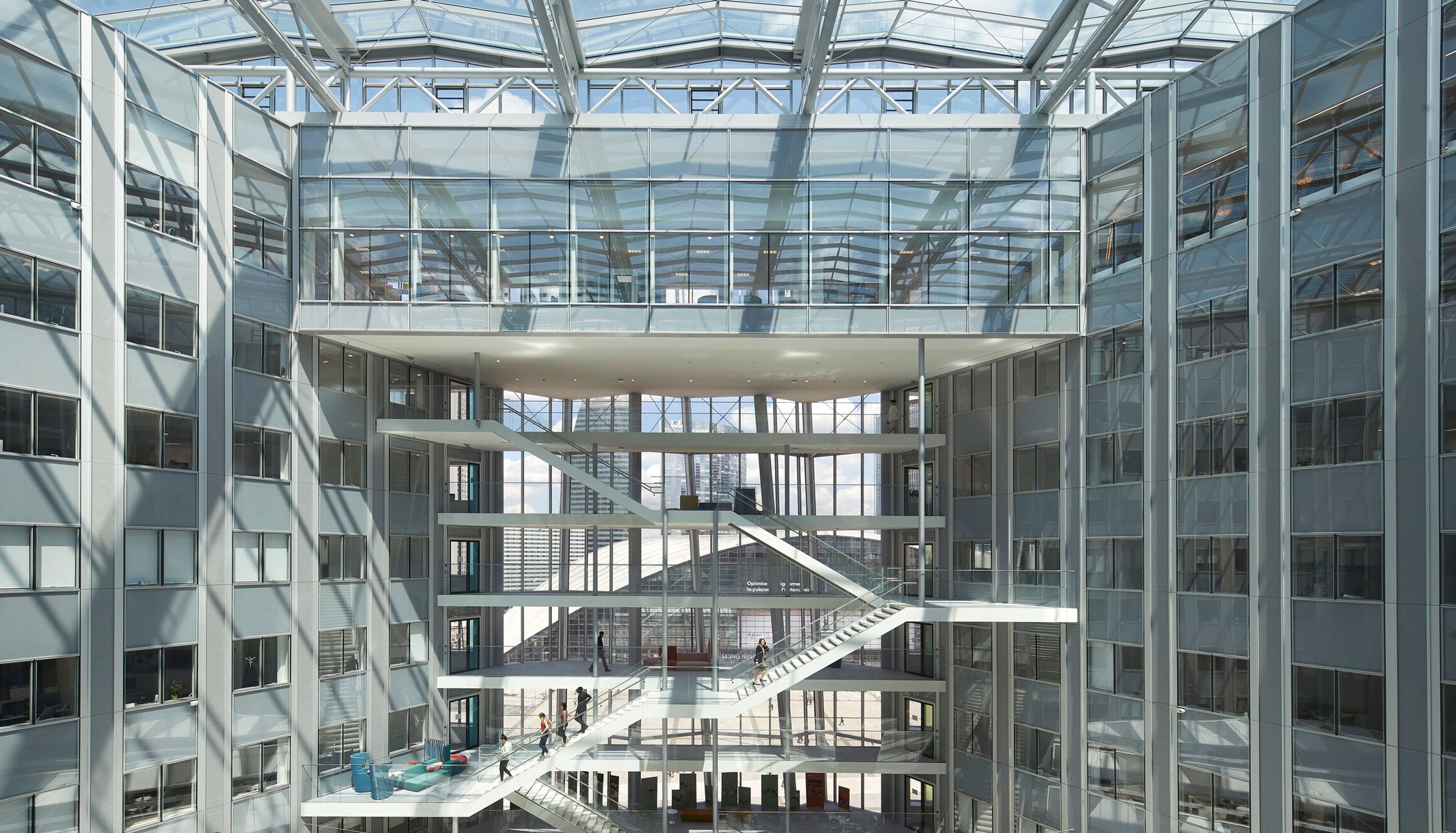 the inside of a large building with a glass ceiling and stairs .