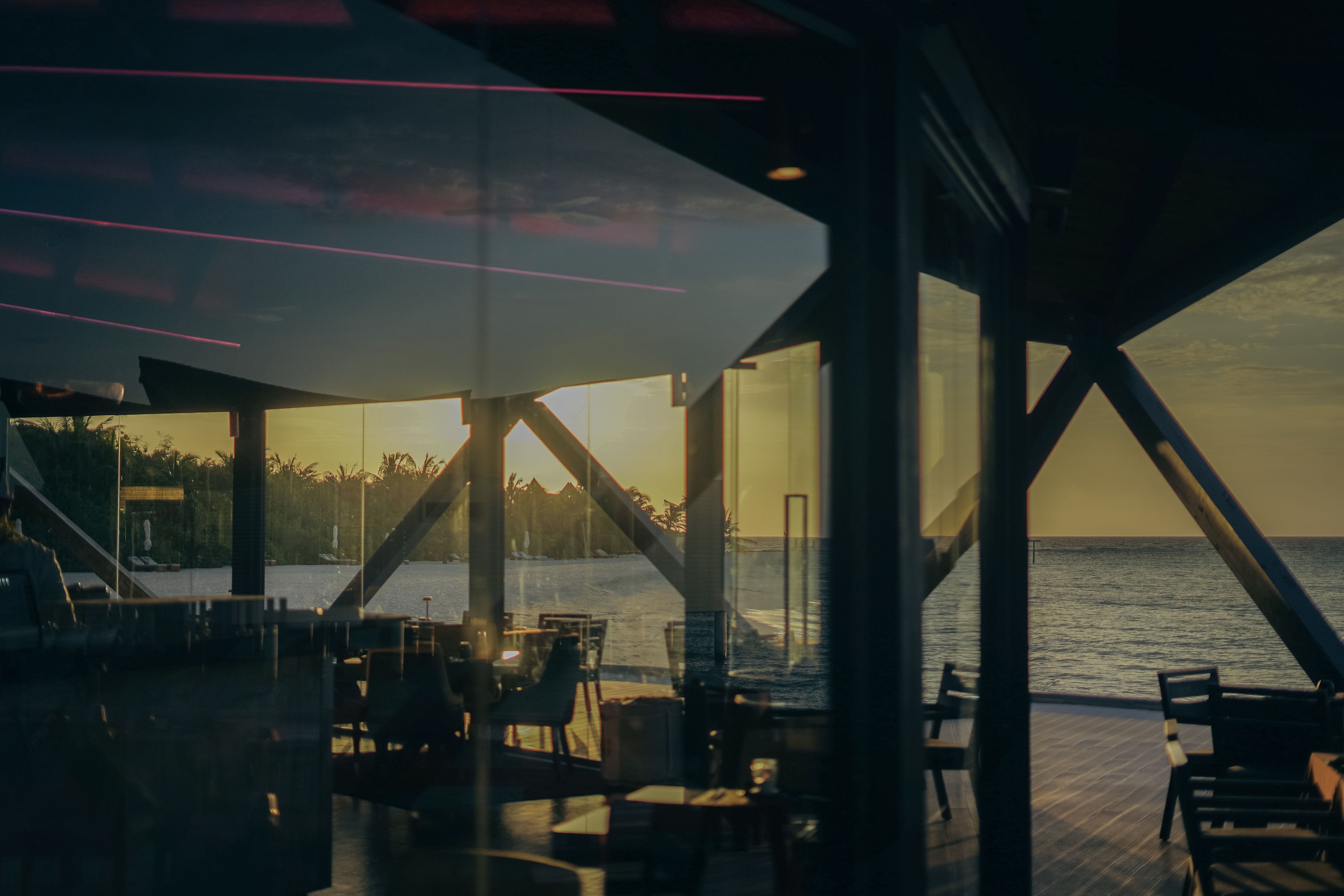 a restaurant with a view of the ocean at sunset .