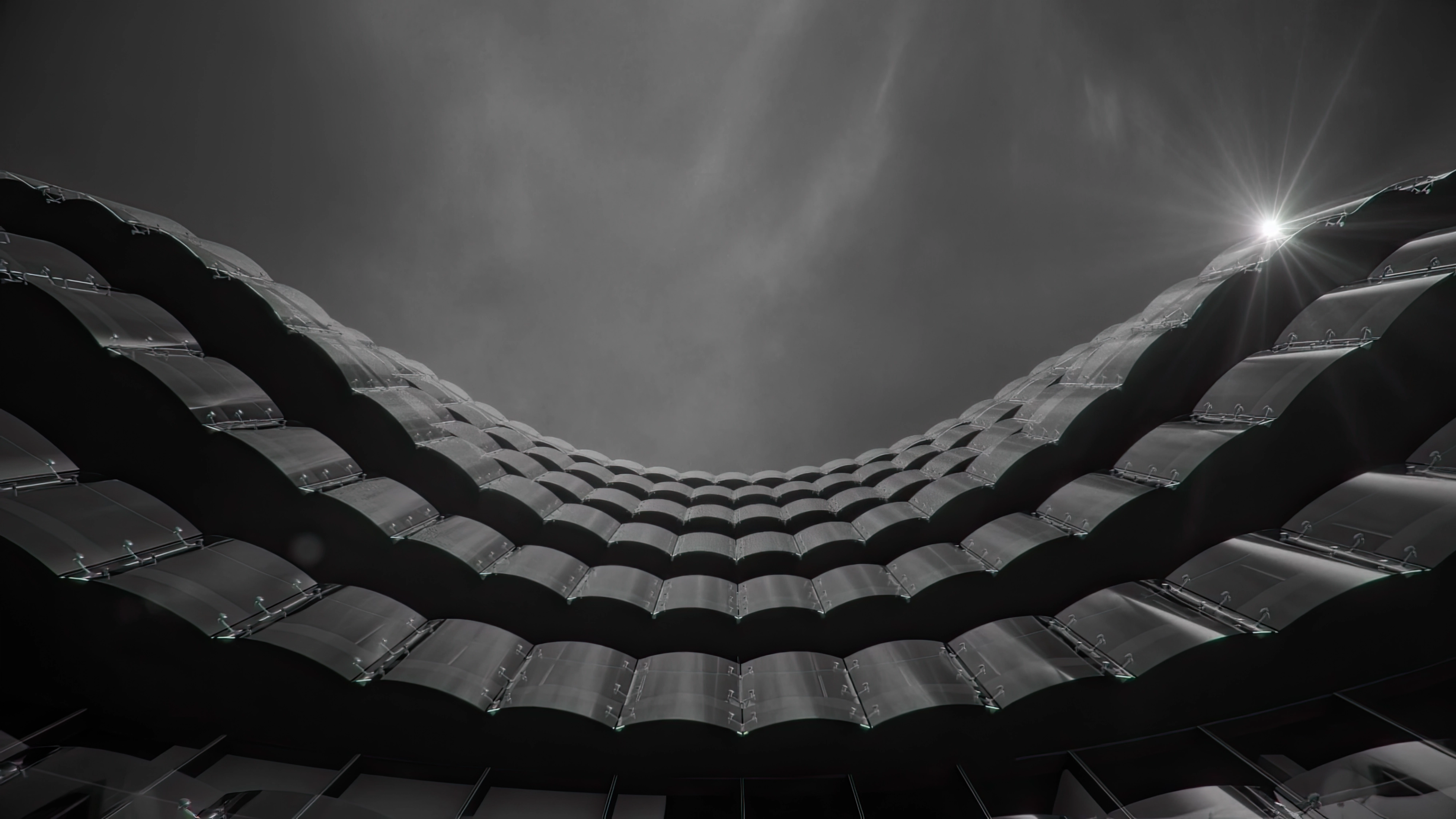 a bedroom with a bed , chair , mirror and large windows .