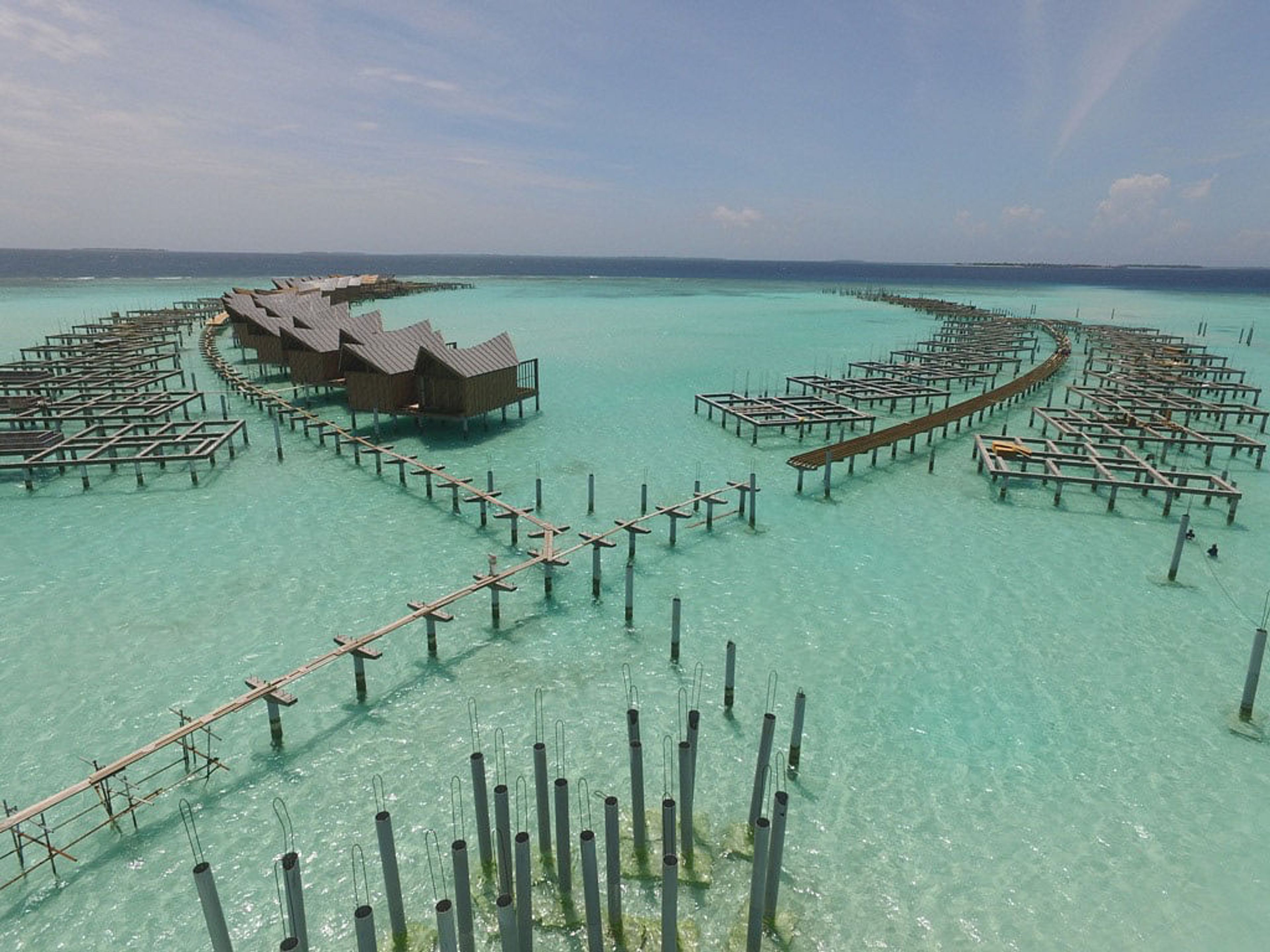 an aerial view of a resort in the middle of the ocean .