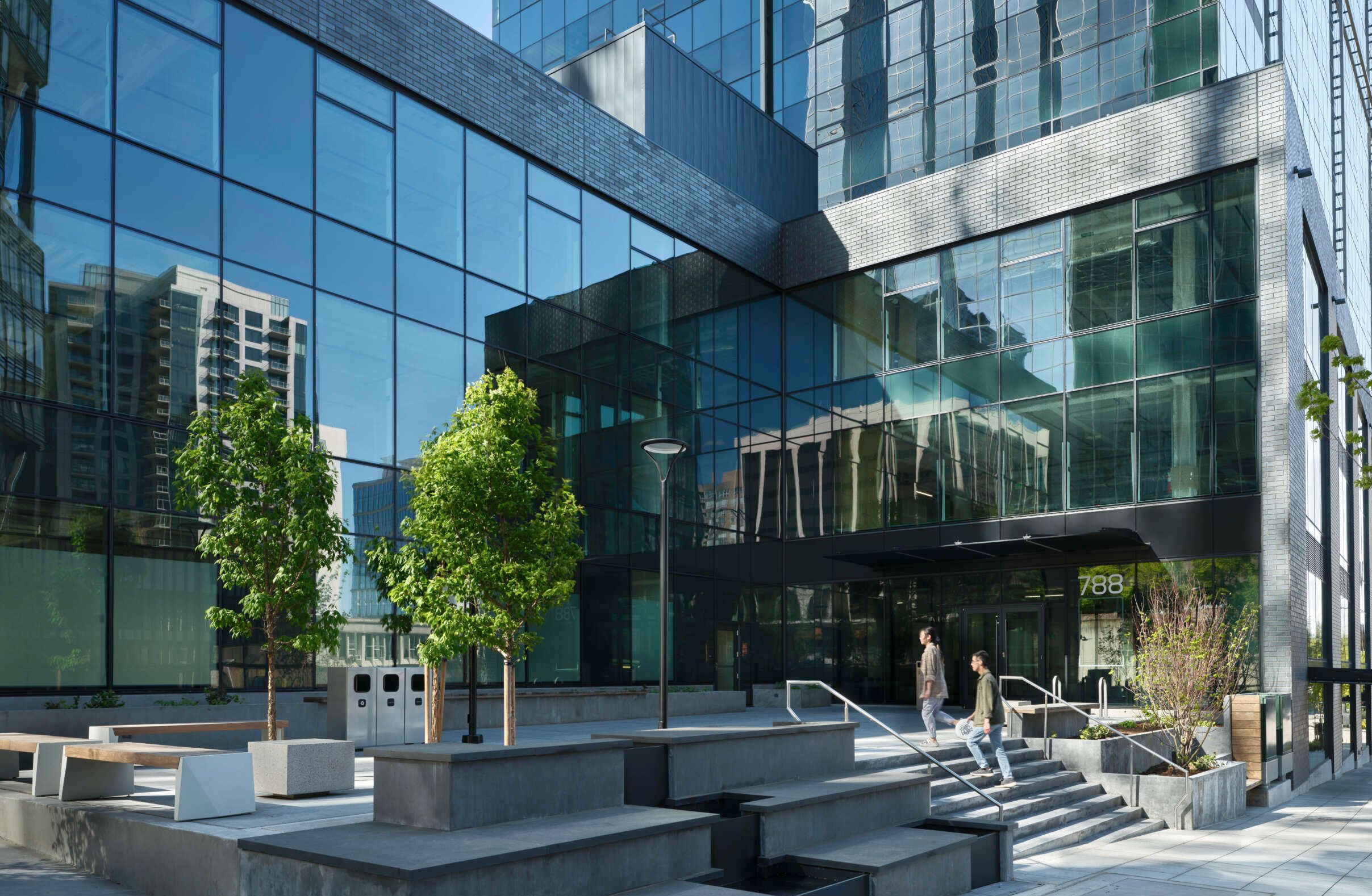 an artist 's impression of a tall building next to a river .