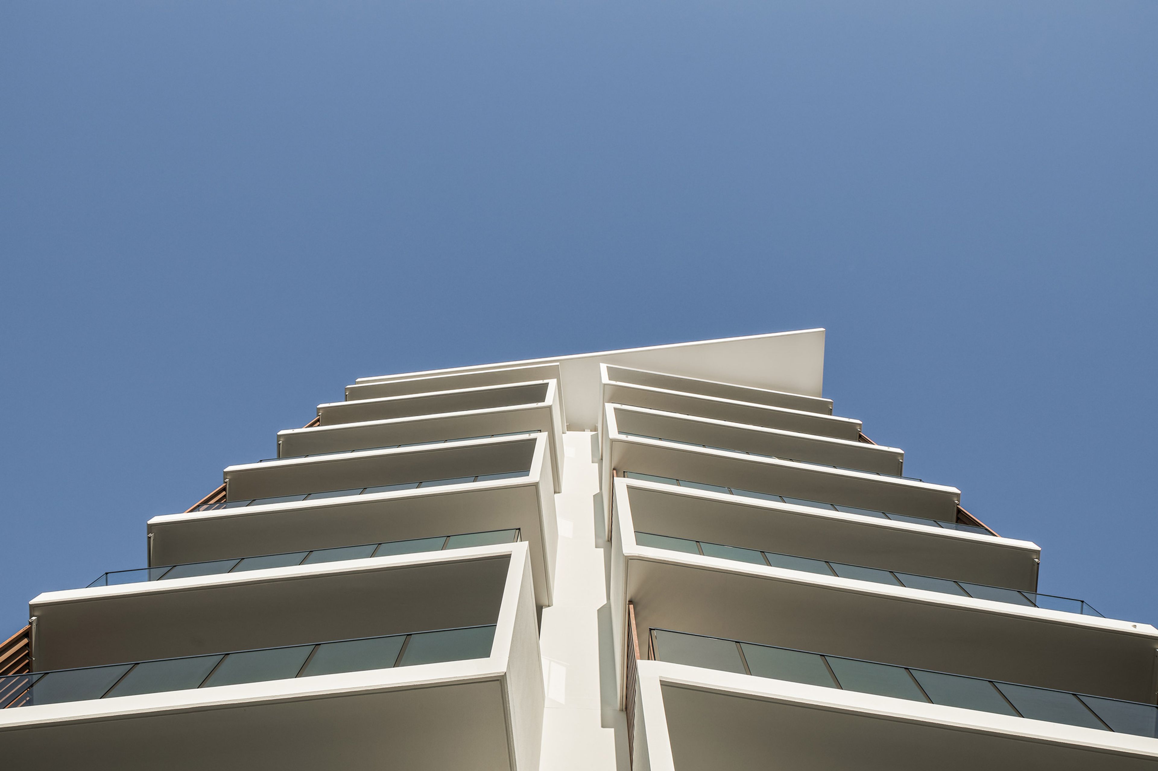 a tall building with a lot of windows is surrounded by trees .