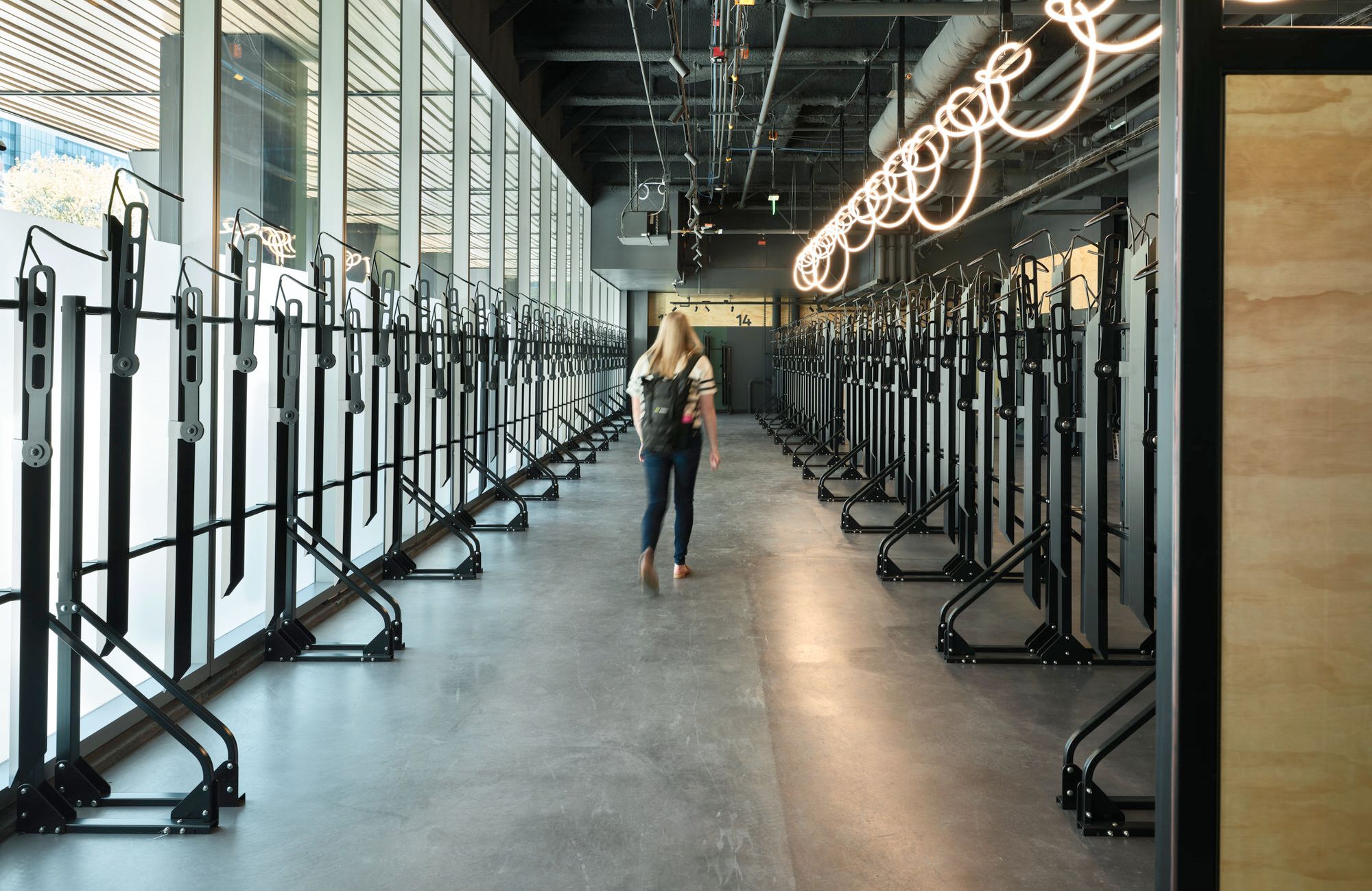 three bottles of perfume are sitting on a table next to a vase of flowers .