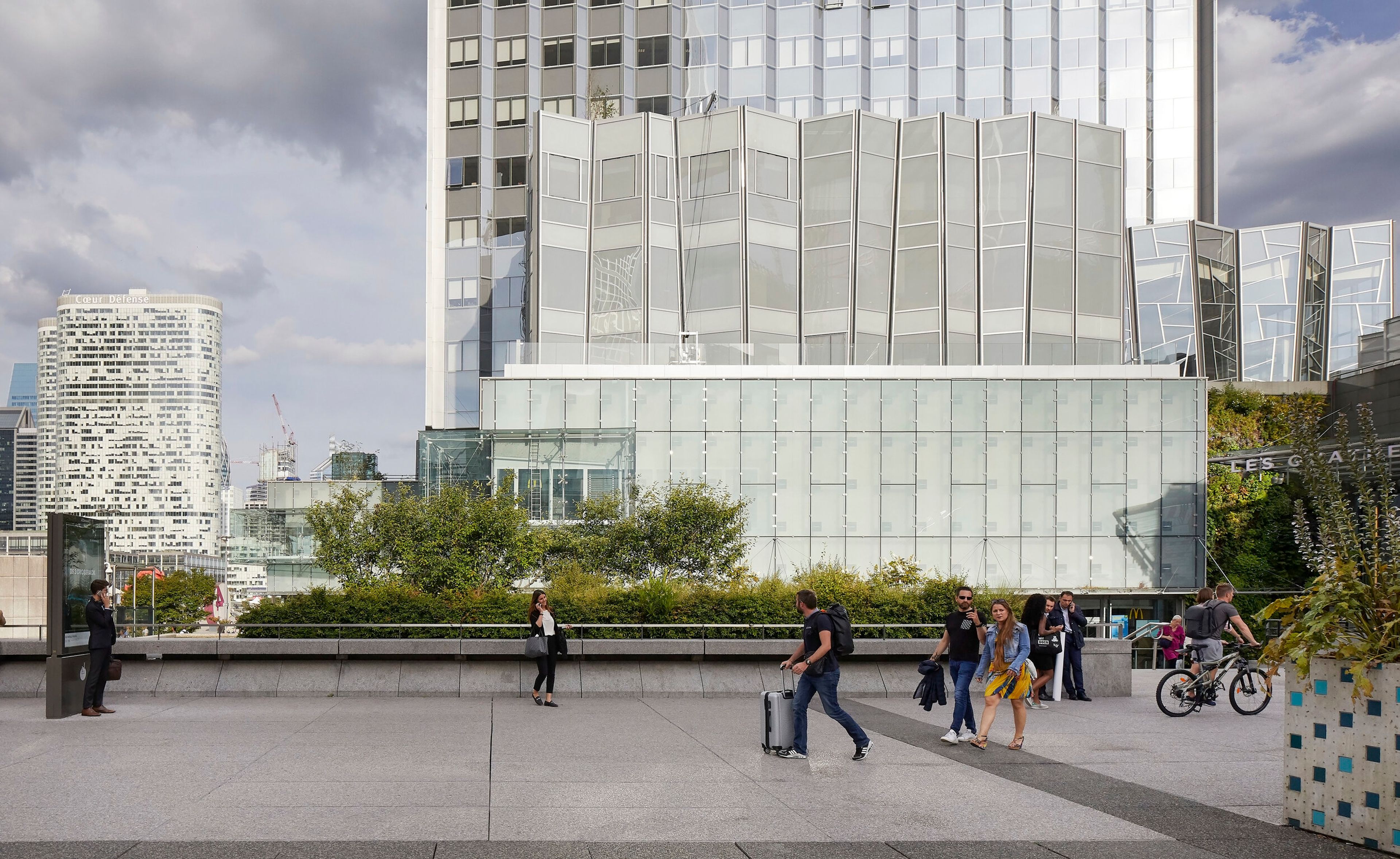 a group of people are walking in front of a large building .