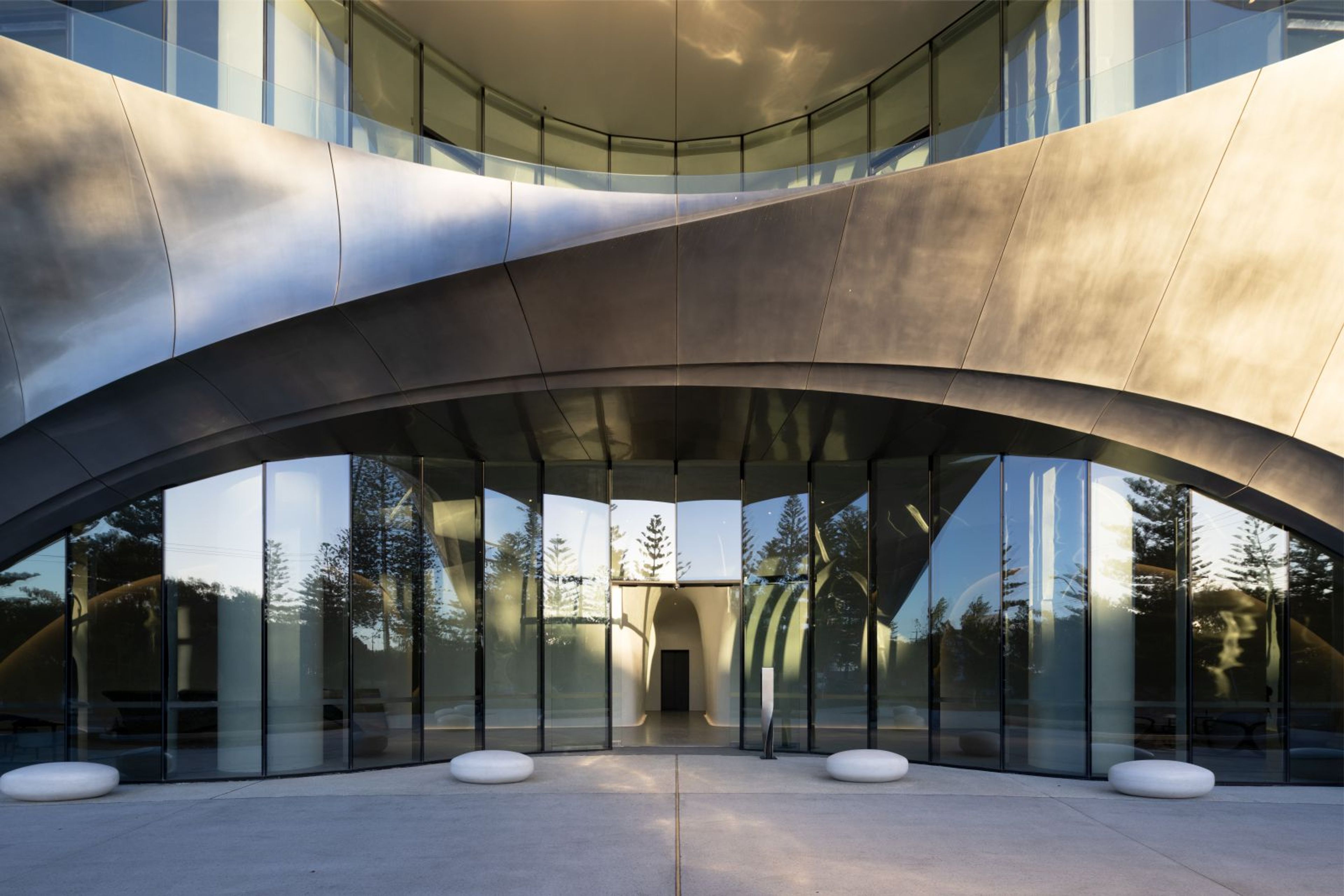 a large building with a lot of windows and a curved roof .