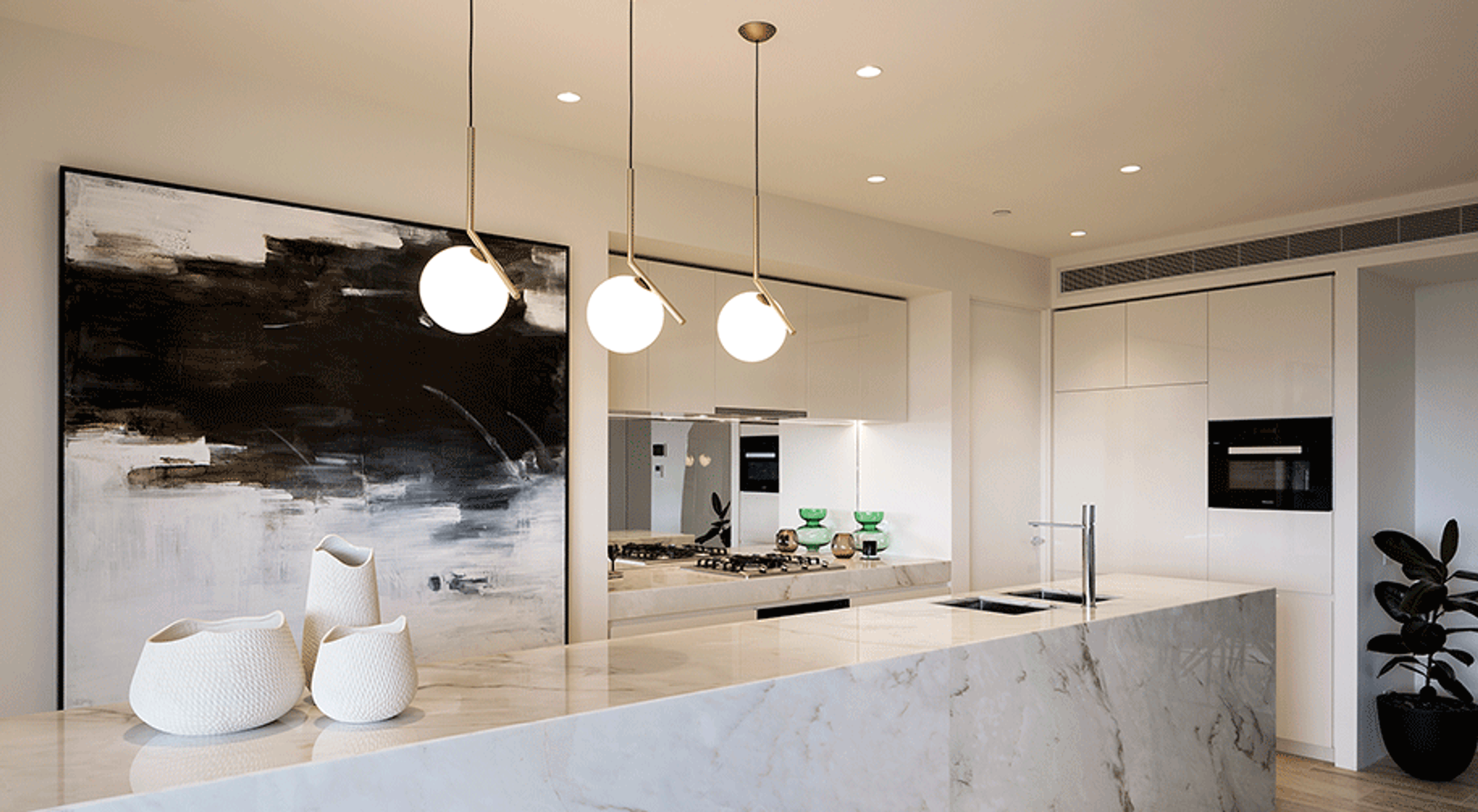 a kitchen with a black and white painting on the wall