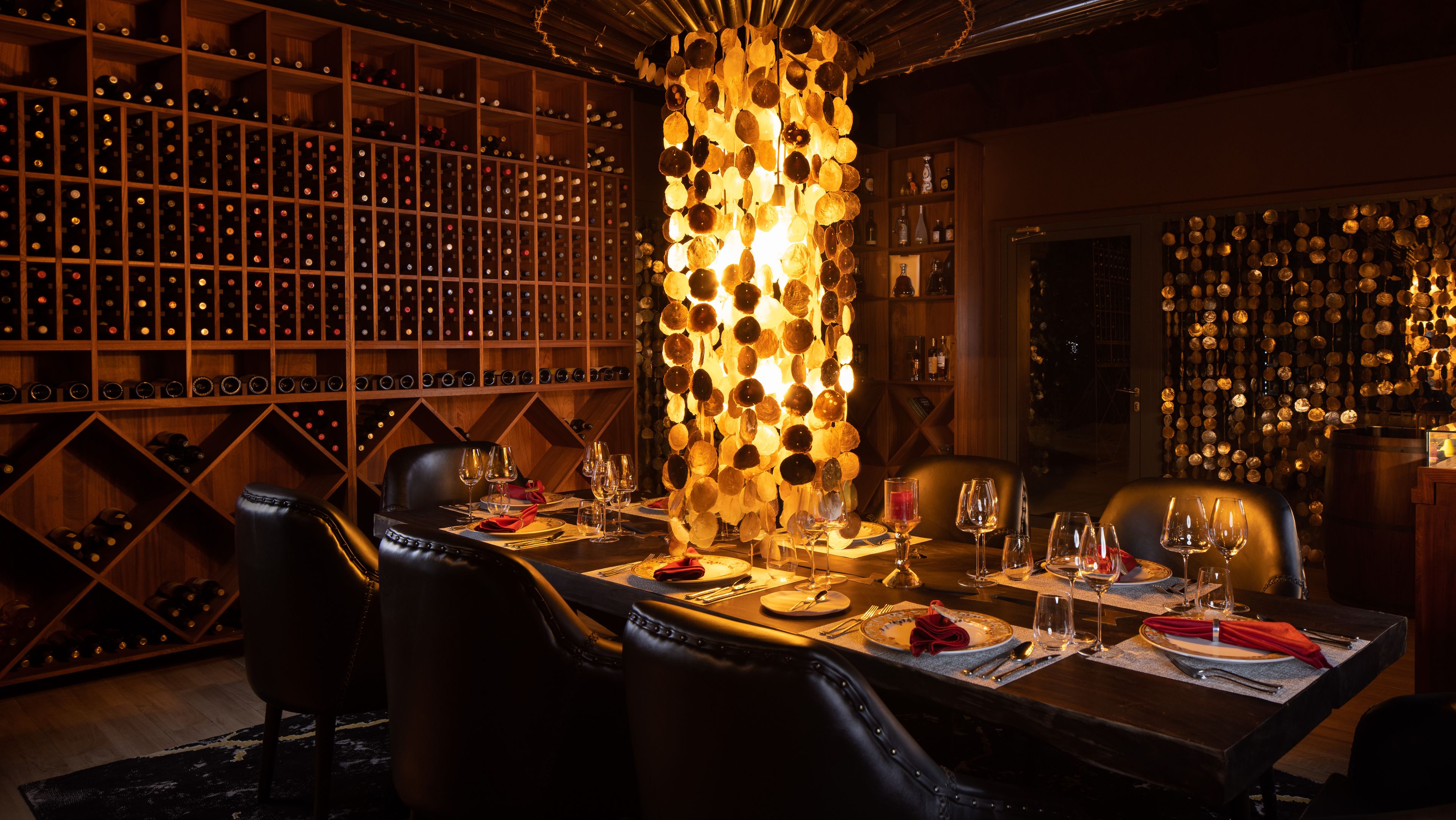 a dining room with a long table and chairs in a wine cellar .