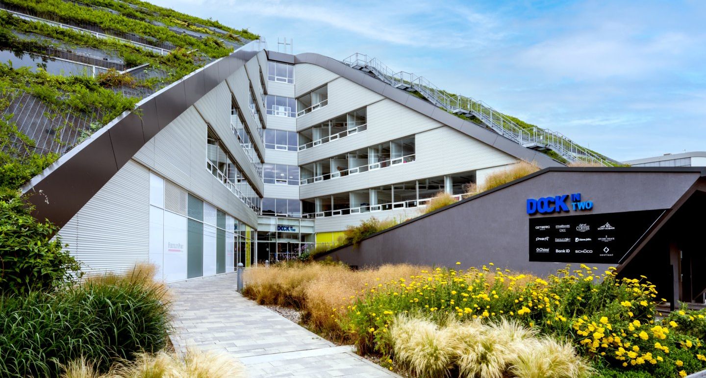 a group of people are walking in front of a large building .
